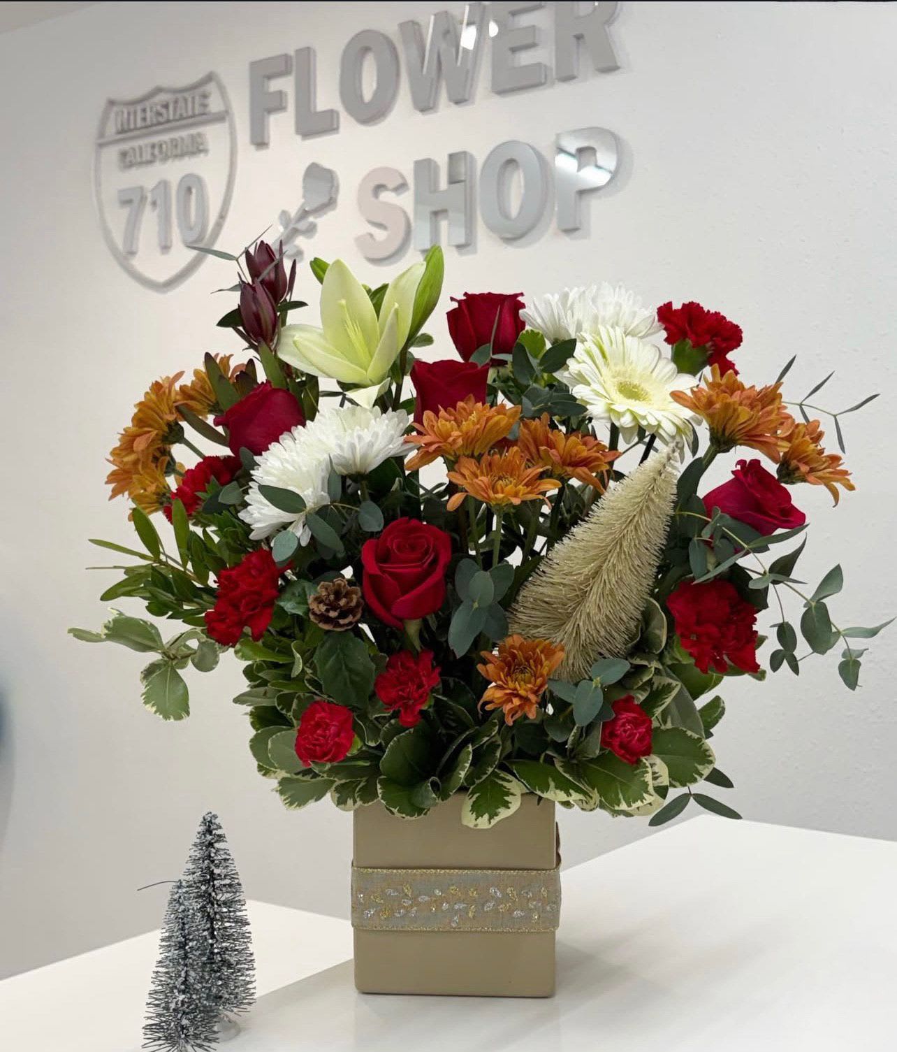 Winter Ember Elegance - Winter Ember Elegance captures the glow of the season, this arrangement blends classic holiday tones with modern sophistication. Perfect for winter celebrations, heartfelt thank-yous, or adding cozy beauty to any space. (If some flowers and/or the vase are not available there will be minor substitutions.)