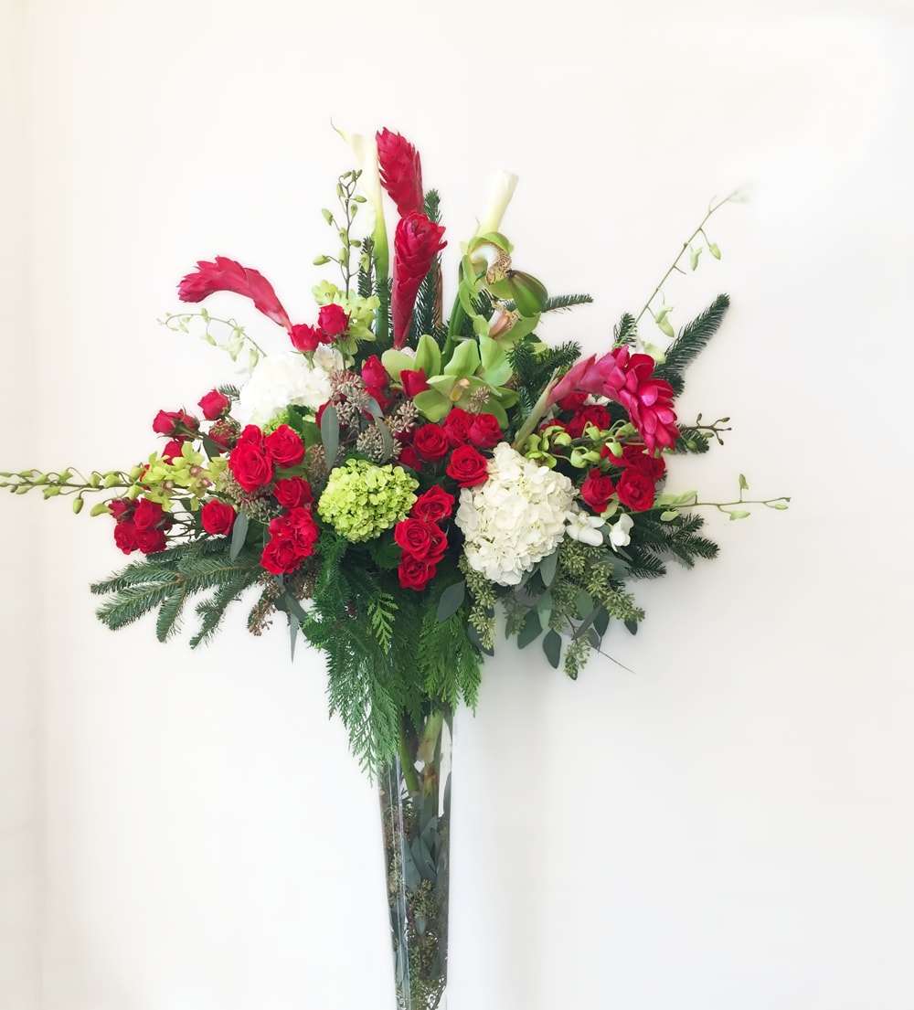 Oversized Christmas arrangements  - Large arrangement with red roses, ginger, orchids and beautiful evergreens.