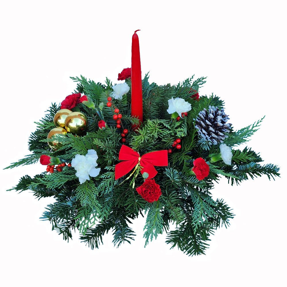 Holiday Traditions Centerpiece - Holiday Traditions Centerpiece – Classic Christmas Greens &amp; Candle  Welcome your loved ones home with the warmth and magic of the season. Our Holiday Traditions Centerpiece is a timeless holiday design featuring assorted Christmas greens, pinecones, festive ornaments, seasonal florals, and a classic taper candle. Rich in texture and traditional charm, this centerpiece creates an inviting focal point for holiday dinners, gatherings, and celebrations.  Perfect for dining tables, entryways, or mantels, this arrangement brings the spirit of Christmas into any space. Approximate size: 12" H x 13" W.  Available Sizes:  • Standard – As pictured, featuring classic holiday greens, décor, and candle  • Deluxe – Enhanced with additional premium florals and festive accents  • Premium – A fuller, more elaborate design with extra flowers, ornaments, and seasonal decorations  Care Instructions: Keep your centerpiece away from direct sunlight, heat vents, fireplaces, or open flames to prevent drying. This arrangement is designed in OASIS® floral foam—keep the foam moist by adding water every other day or as needed so the greens and florals stay fresh throughout the holiday season.  Celebrate the season with a traditional Christmas centerpiece that brings warmth, joy, and holiday elegance to your home.