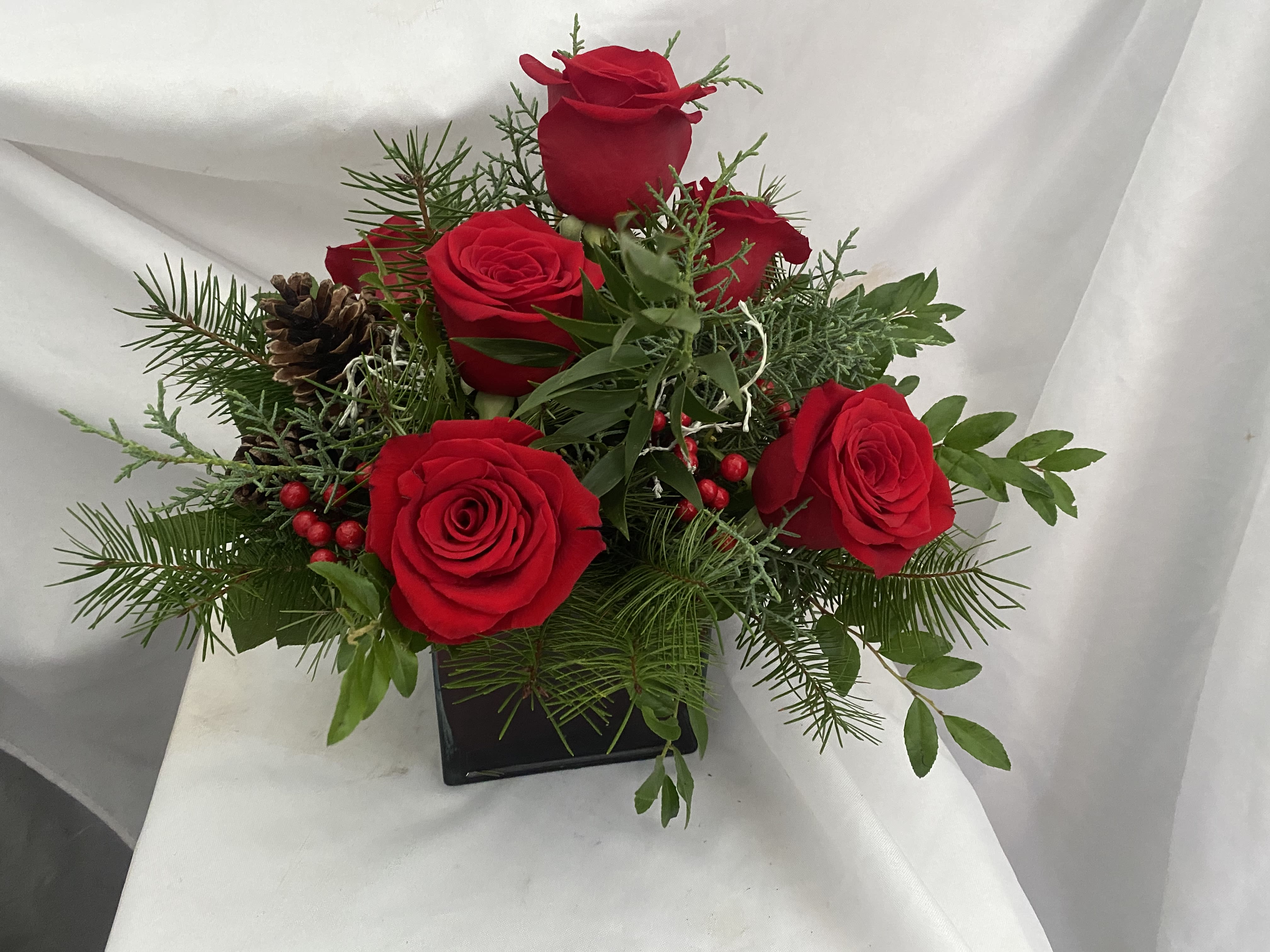 Christmas Bliss - Blend of seasonal greens with red roses, pine cones, and berries to inspire your Christmas spirit.