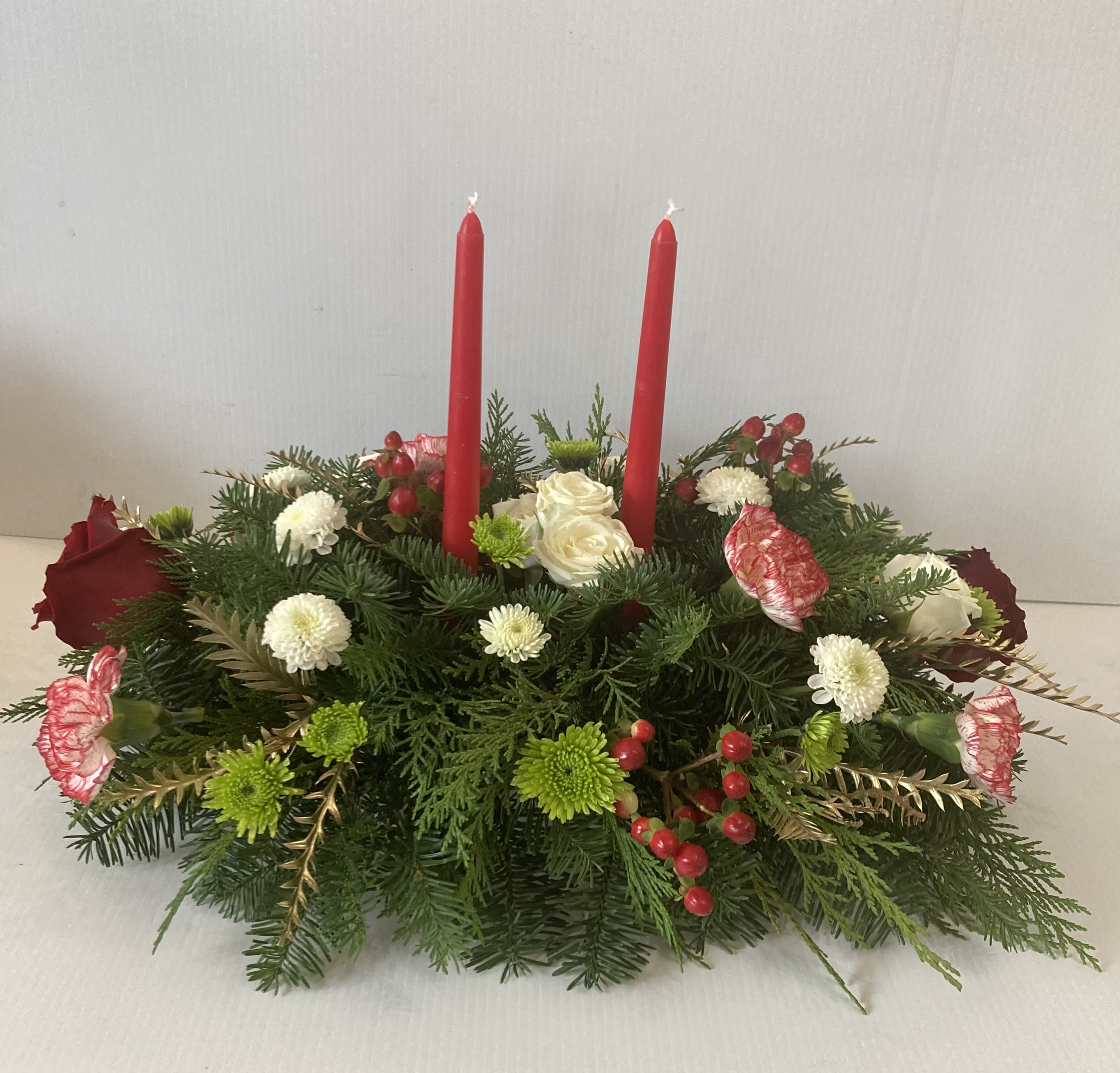 Christmas center piece - Christmas greens, roses, carnations and berries