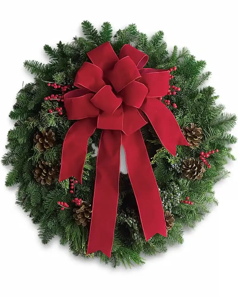 CLASSIC HOLIDAY WREATH - The holidays are knocking at the door. Luckily, here's a gift that always gets a warm welcome! It's a classic holiday wreath with some very lovely extras. A beautiful noble fir wreath with juniper branches, pinecones and berry sprays is adorned with a brilliantly festive red velvet bow. Anyone would be delighted to have this arrive on their doorstep