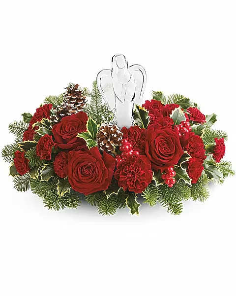 Evergreen Blooms - Evergreen Blooms Bouquet features radiant red flowers, holiday greens, and a sparkling crystal angel centerpiece-perfect for Christmas, memorials, or sending peace and love this season. Evergreen Blooms Bouquet features red roses, red carnations, and red miniature carnations. Accented with noble fir and variegated holly, surrounding a beautiful crystal angel keepsake.