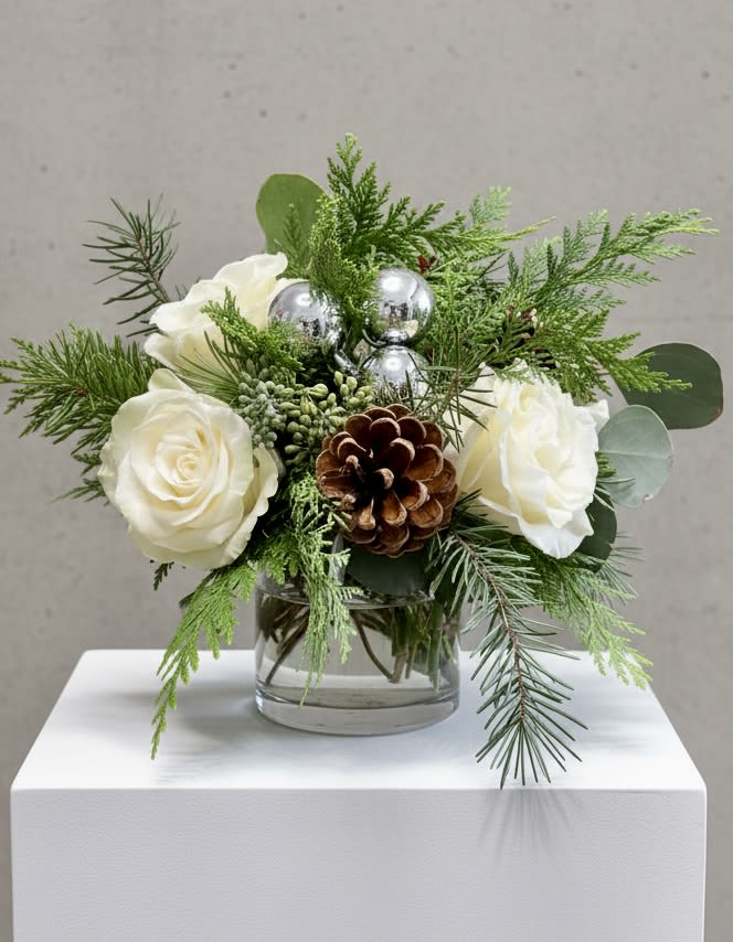 Wintery White Small Low Centerpiece - 1 Available - Our wintery arrangement of white roses, silver balls and pinecones among a variety of everygreens