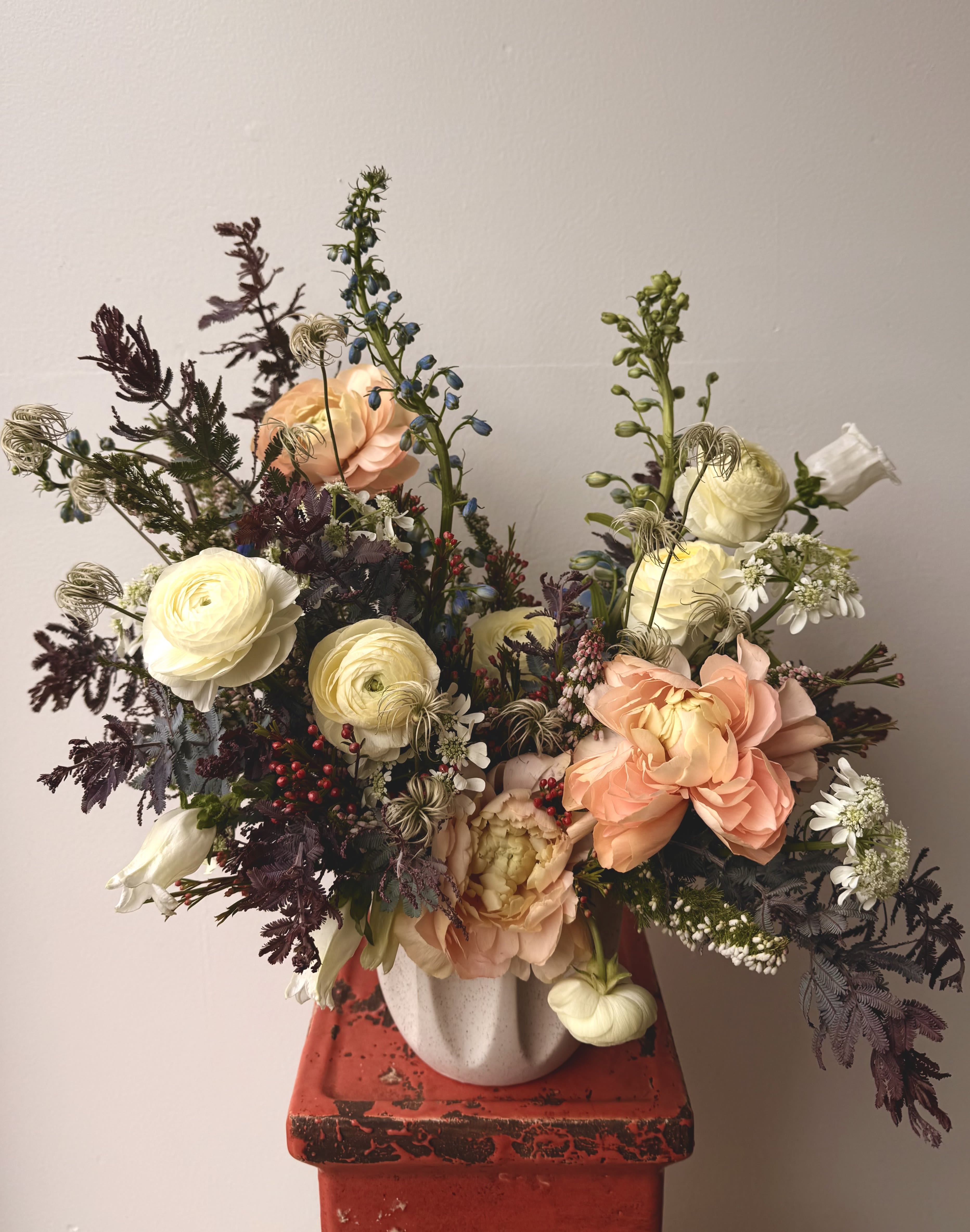 Soft Designer's Choice - If you’re familiar with what we do and want us to create something distinctive and special for you, this is the perfect choice! Pictured is not representational of color or flowers included. However, you can expect the "soft" designer's choice to feature a variety of pastel and white tones for a gentle and idyllic design.  *Deluxe size pictured*  Concerning Seasonality: As a seasonal, locally-focused florist, we have different product to work with each week. Our focus is on creating a unique piece for each customer, with blooms that are fresh from local farms and growers. While the flower varieties and colors may vary, the quality and freshness will always be the best. It is an honor to have our customers' trust and confidence in our abilities and artistic eye.   Delivery Policy: Pick-ups at the studio are available after 2pm. Our daily delivery time frame is typically between 12- 3 PM. Please specify if you require a certain delivery time and we will do our best to accommodate it, or we will call you if we cannot. Please include any gate codes if applicable! If there is no answer at the door, our delivery person will leave the flowers by the doorstep in a weather safe location or contact you to reschedule the delivery.  Completing your order acknowledges that you have read and understand our delivery policies. 