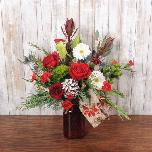 Holiday Greetings - Red mason jar filled with holiday blooms designed with a modern country touch.