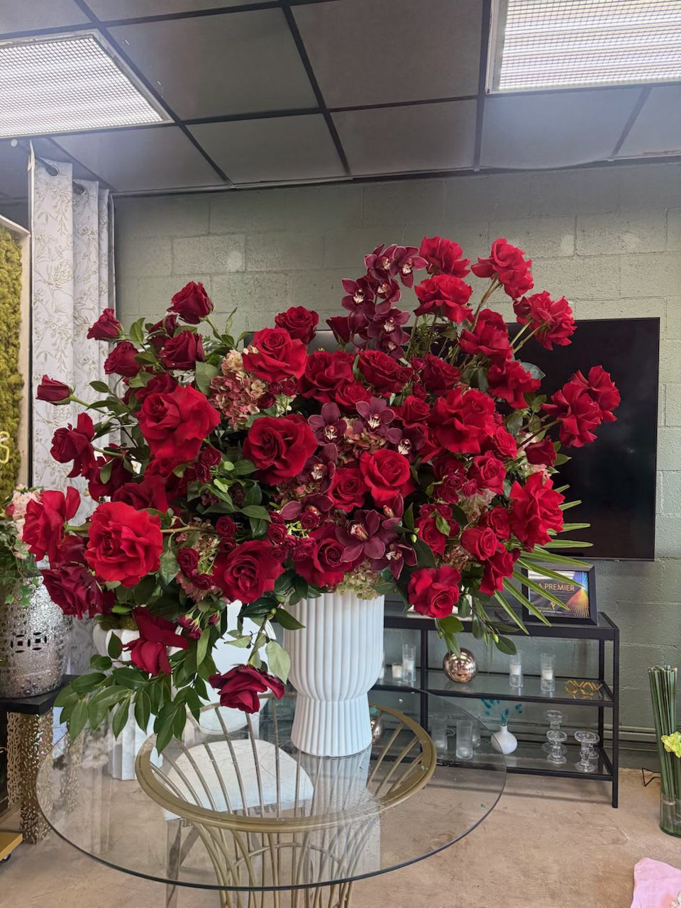 Valentine - A stunning array of red Roses, Spray Roses, burgundy Cymbidium Orchids, and Hydrangea