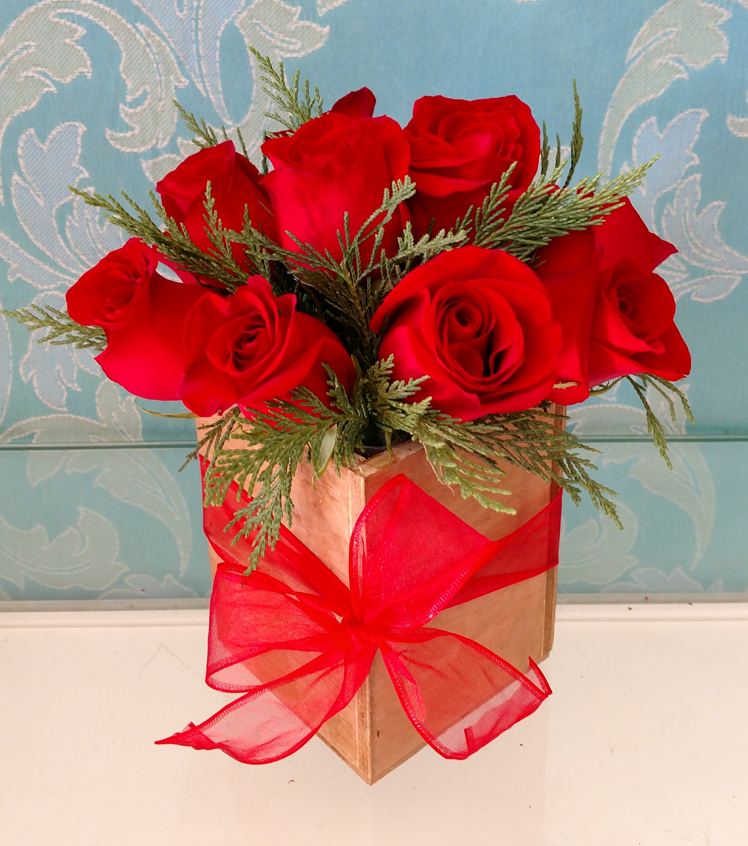 Holiday  Dozen Red Rose Box - This eye-catching arrangement offers a modern twist on the classic red rose bouquet. Rustic 1 dozen Roses make a great gift for The holidays, a birthday, or just to let someone know you're thinking of them.