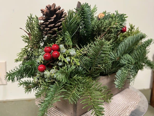 Magic Forest Centerpiece - A sturdy wooden box filled with seasonal greens including berried juniper, balsam fir, and Port Orford cedar accented with red berries and spruce cones.  (local pickup or delivery only)