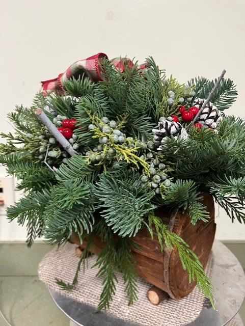 Country Log Centerpiece - A wooden "log" contains the best of the holiday season!  Balsam fir and berried juniper.  Spruce cones.  Red berries.  A checkered bow.  Perfect!  (Local pickup or delivery only)
