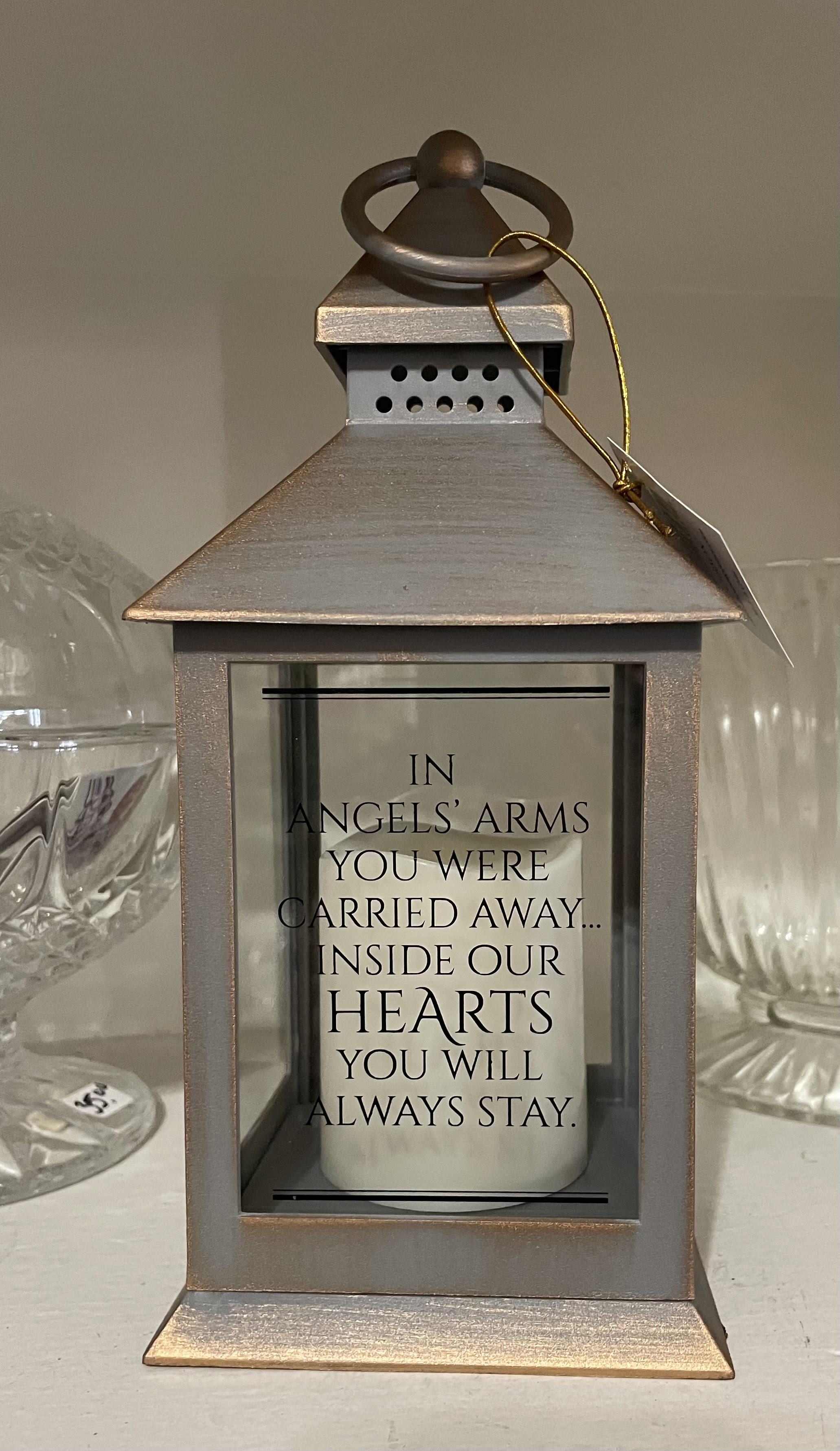 In Angels Arms Small Lantern - Our Inspirational Lanterns in this assortment are made of weather friendly materials and UV printed glass. They include a flameless LED candle with a built-in automatic timer: 6hrs ON/18hrs OFF (3 AAA batteries are included) W: 4" H: 11" D: 4" 