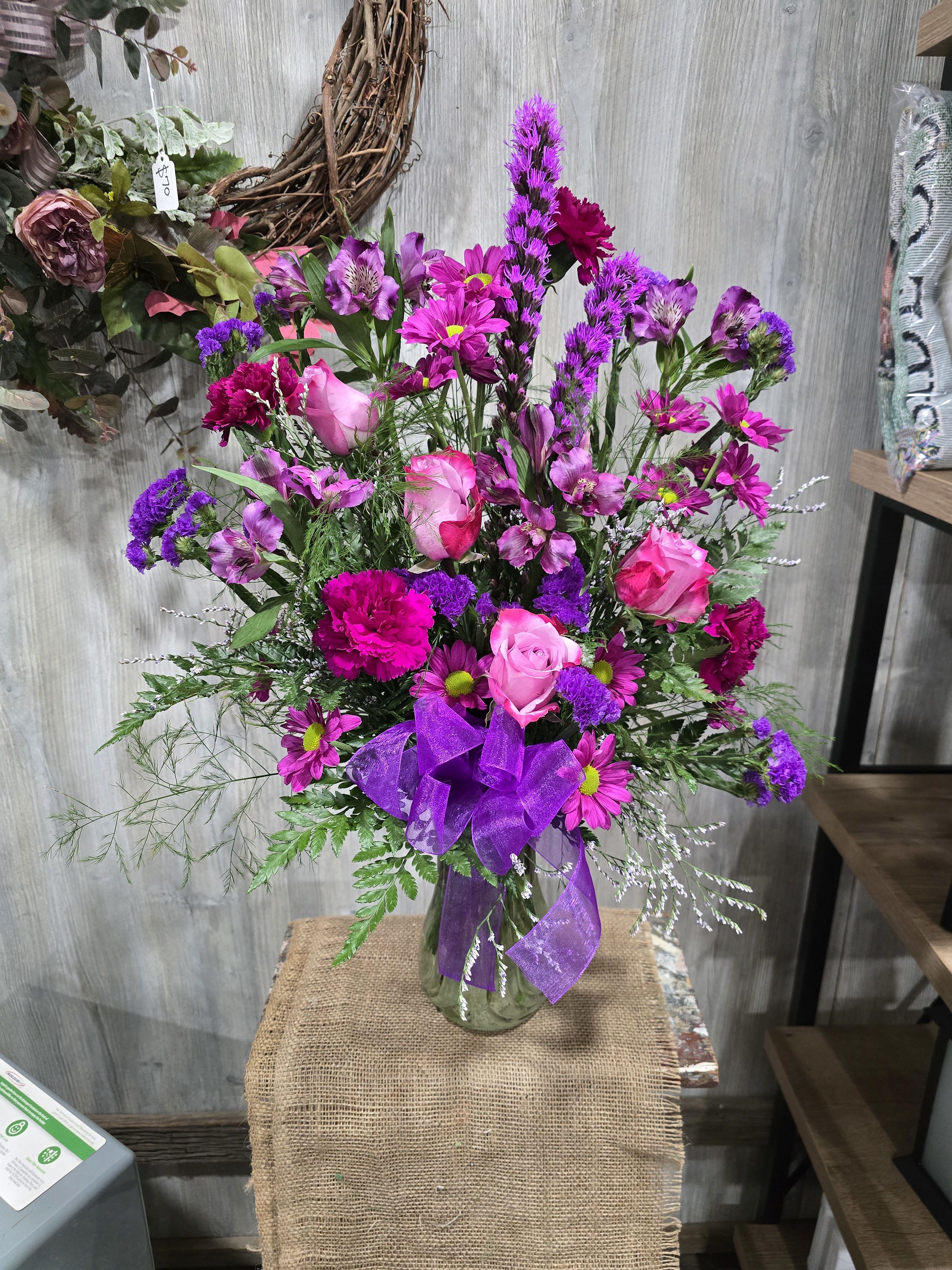 Purple Passion - Beautifully designed with deep purple roses, carnations, liatris, and lavender daisies! 