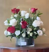 Eternal Bloom - Serenade your love with this beautiful bouquet of red and white roses! Designed with premium red roses and elegant white lisianthus in a leaf-lined cylinder vase, this arrangement is sure to capture anyone’s heart.