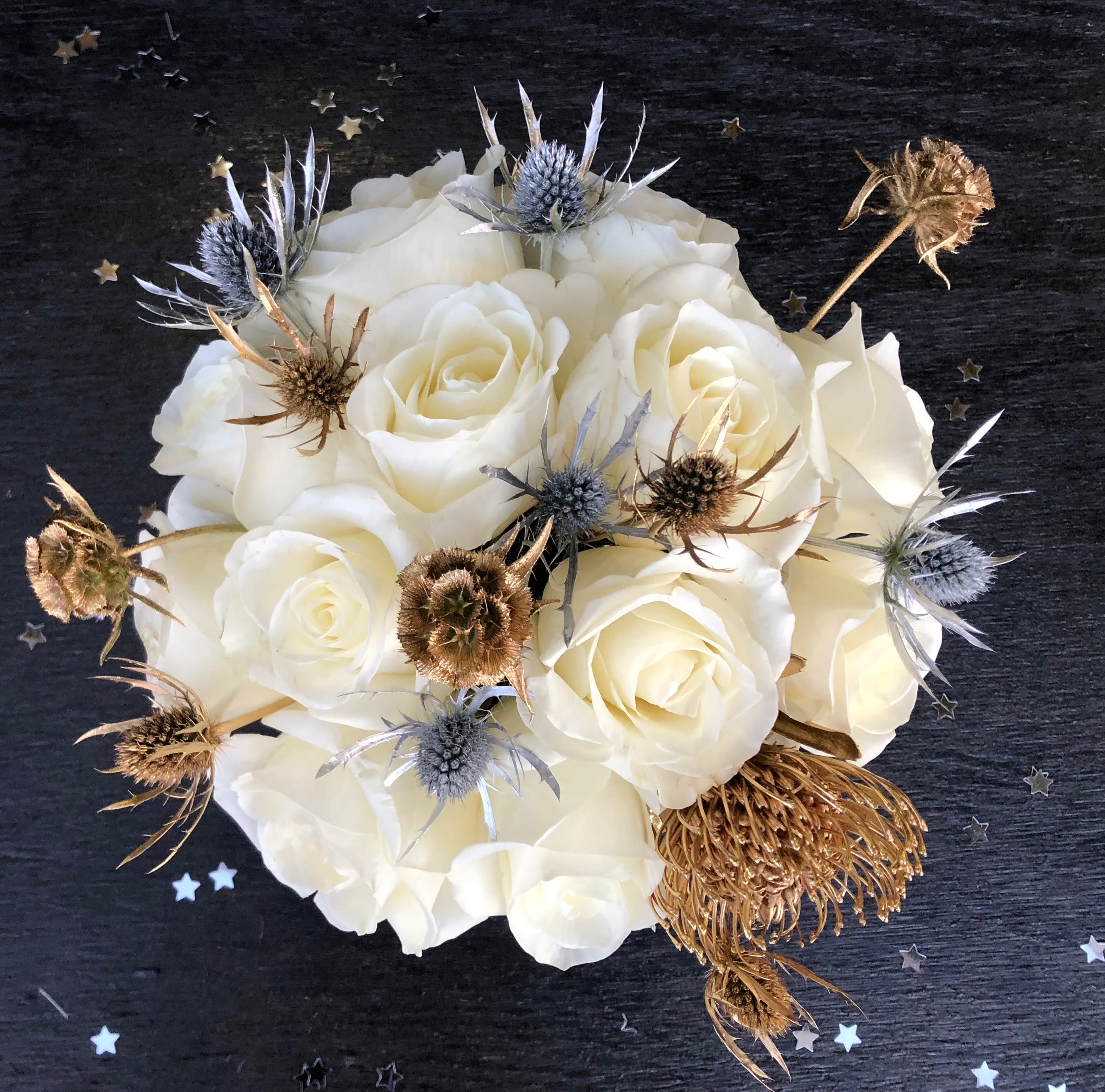 Cheers to You! - This arrangement is the perfect way to celebrate! White roses with metallic accents are sure to add some sparkle to your day.