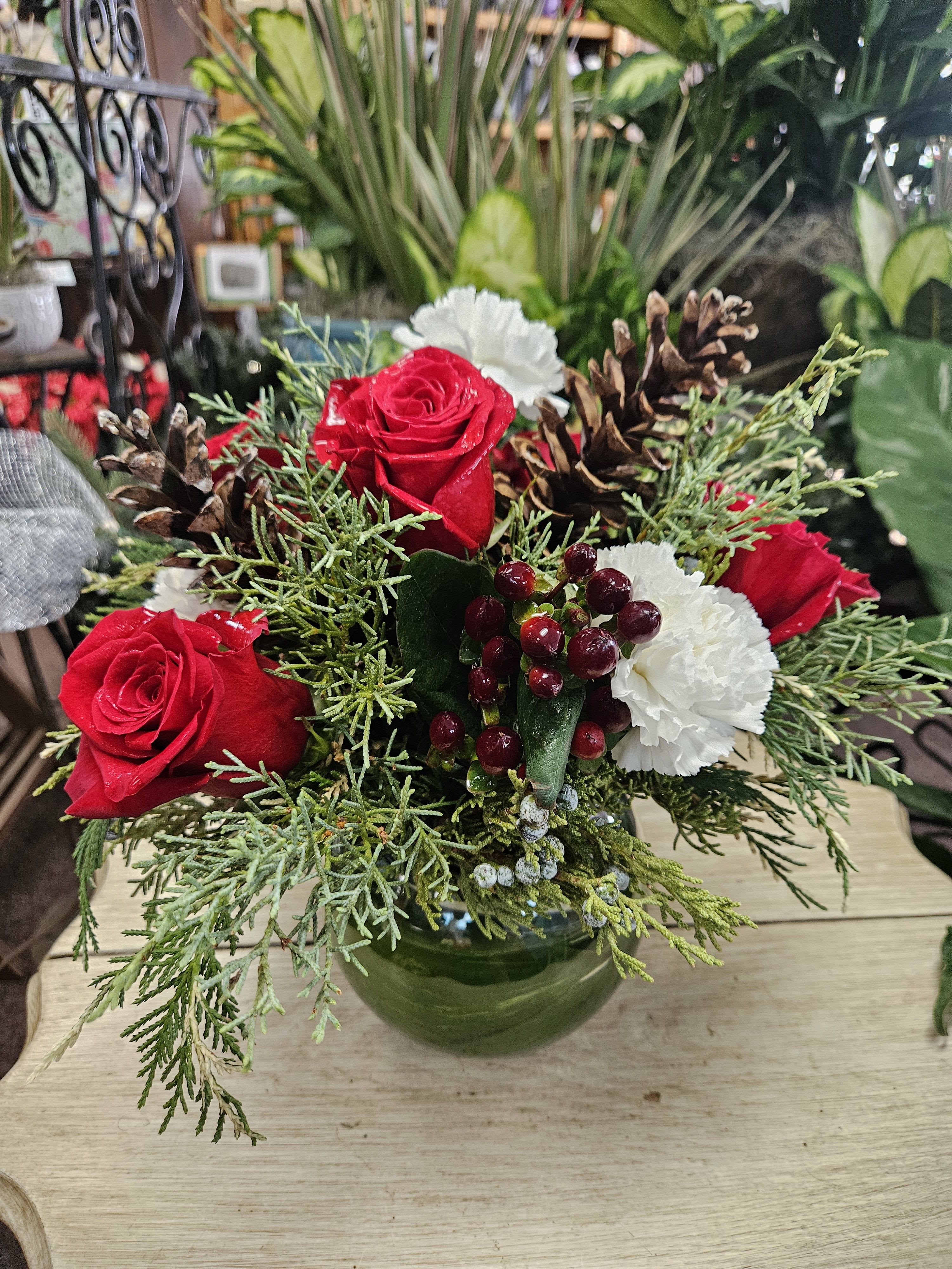 Christmas Bubble Bowl - An elegant rose bowl filled with festive flowers and foliage makes this the perfect touch to add to any room. Roses, cedar fir, and hypericum berries arrive in a clear glass rose bowl. 