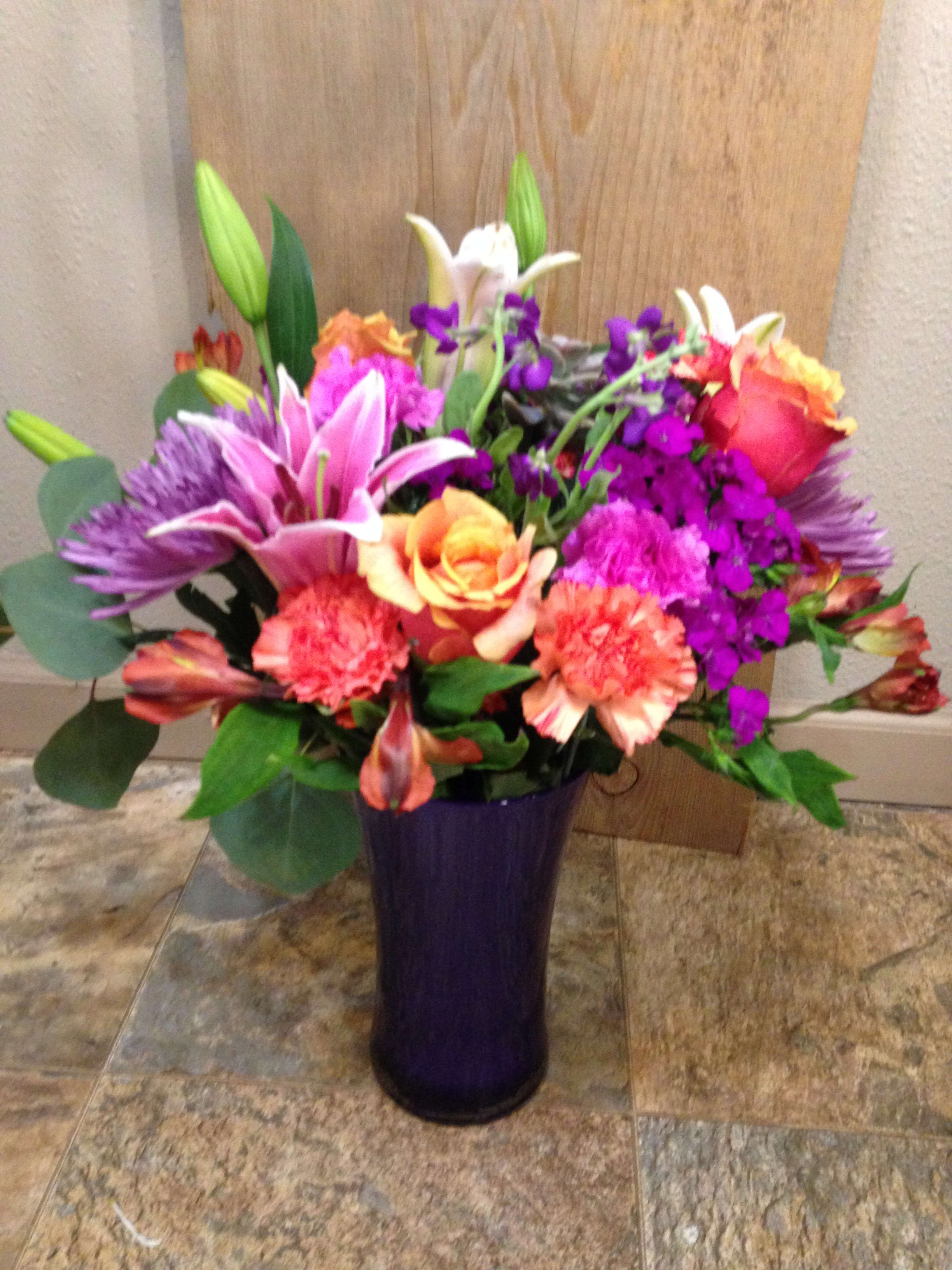 Beautiful Blooms - Lillies ,Roses, Alstro. Seasonal, Flowers in a clear vase.
