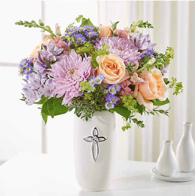 Graceful Cross Vase - The Graceful Cross Vase offers a gentle expression of sympathy with its soothing blend of purple and peach blooms. Arranged in a classic vase, this elegant mix symbolizes peace, hope, and heartfelt remembrance—bringing comfort in times of loss.