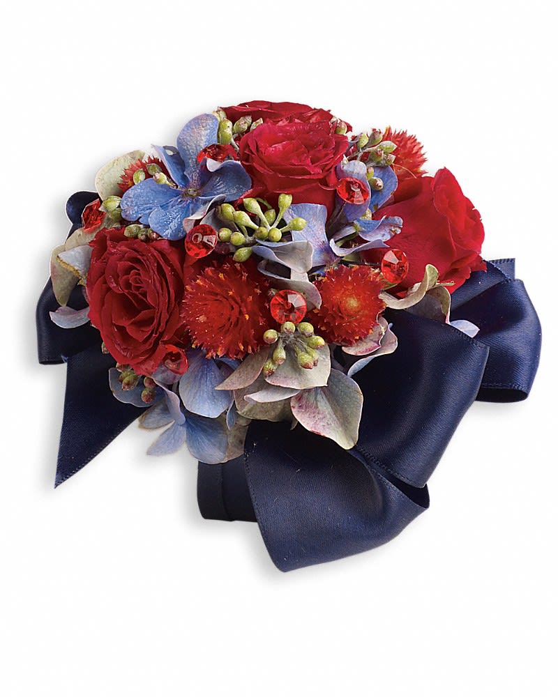 Camera Ready Corsage - Bold and beautiful in ravishing red roses and pale blue hydrangea. Light blue hydrangea, red spray roses and red gomphrena.