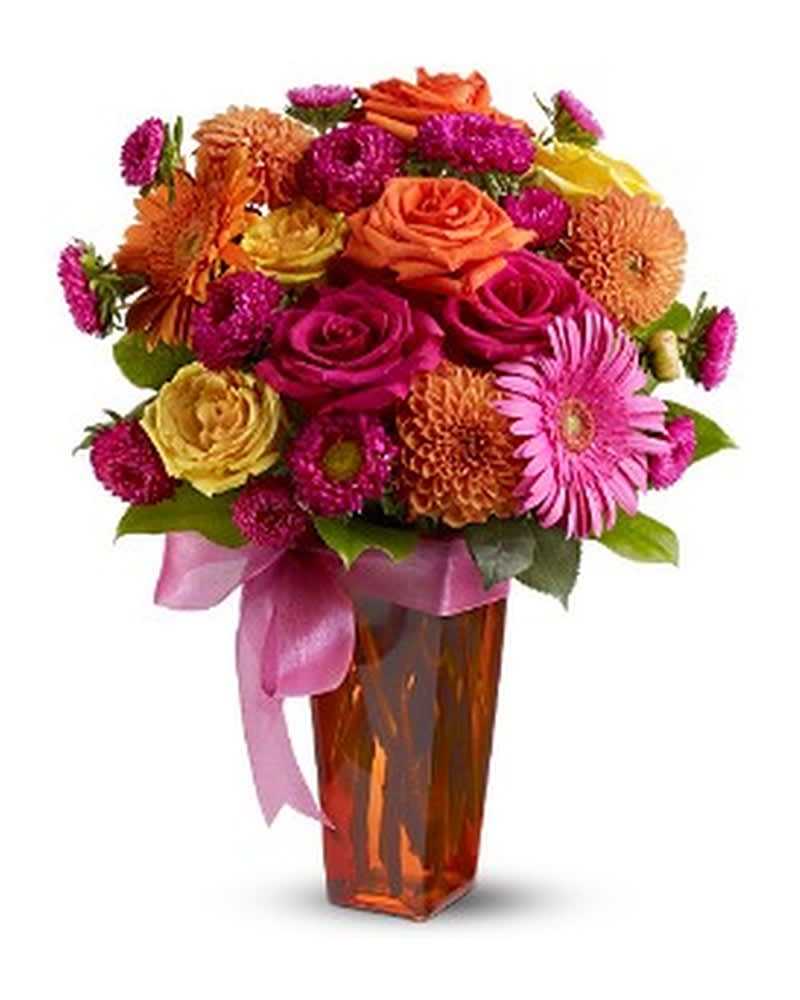 Strikingly Chic - An eye-catching display of blossoms in sizzling hues of hot pink, fiery orange and sunshine yellow is arranged in a tall glass vase that's decorated with a pink bow. A chic and stylish floral arrangement that's guaranteed to impress for a birthday or any special day. A mix of fresh flowers such as roses, dahlias and gerberas â in shades of hot pink, orange and yellow â is delivered in a glass vase thatâs decorated with a pink ribbon. Approximately 11.5" (W) x 17" (H) Orientation: All-Around As Shown : TFWEB305