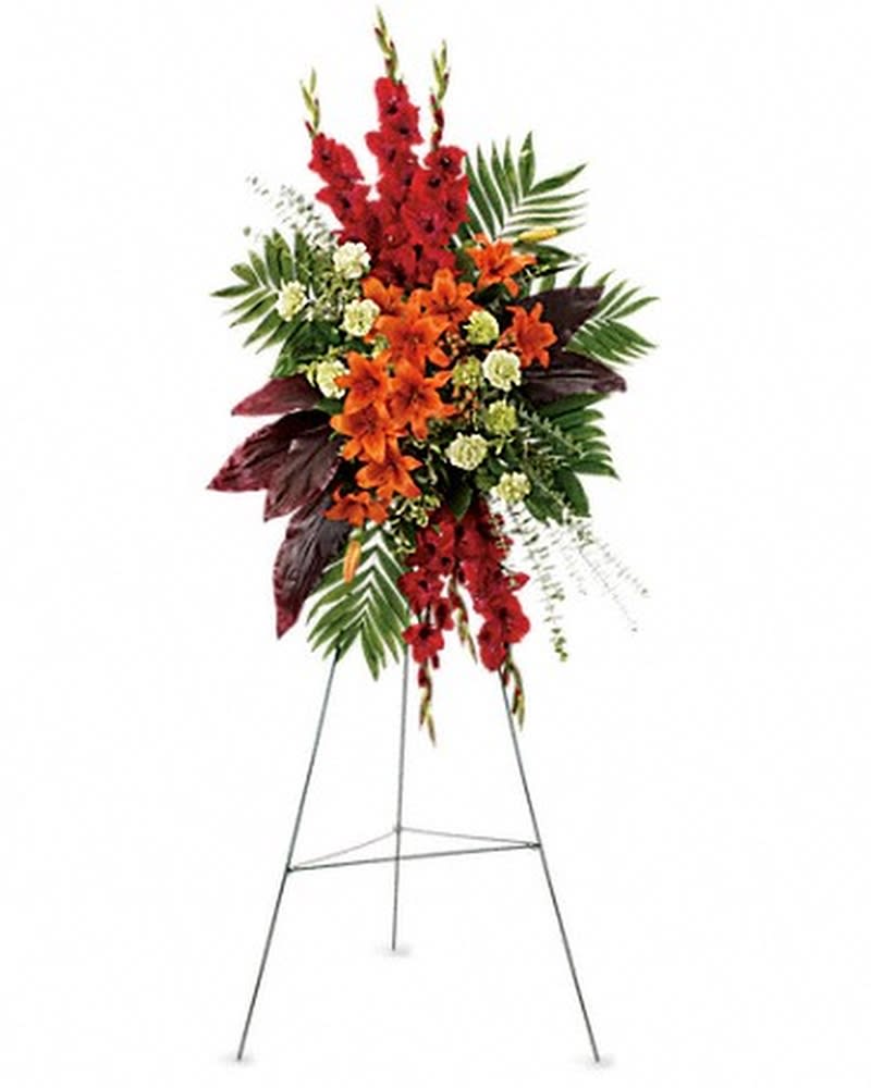 A New Sunrise Spray - When a loved one has passed, this radiant spray of red and orange flowers will be a reminder of happy times past that will never be forgotten. The stunning arrangement includes orange Asiatic lilies, red gladioli, green carnations, peach hypericum, emerald palm and red ti leaves, accented with assorted greenery. Orientation: One-Sided All prices in USD ($)