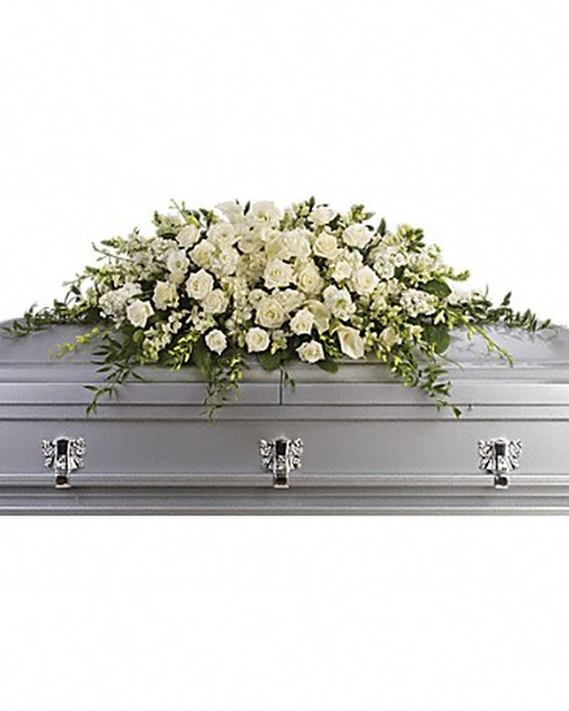 Purity and Peace Casket Spray - A stunning yet respectful testament in white, this spray for the casket includes roses, orchids, calla lilies and hydrangea accented by soft, trailing greens. White roses, orchids, large calla lilies and perfect stems of hydrangea. Approximately 47" W x 17" H. Orientation: N/A All prices in USD ($)
