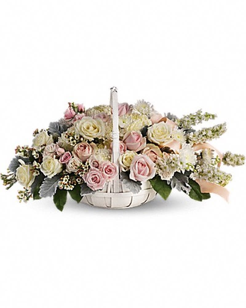 Dawn of Remembrance Basket - To offer comfort and consolation, these serene, softly colored roses and chrysanthemums are nestled in a round white basket with handle. Satin ribbon is threaded throughout to complement the soft look. Beautiful blooms such as white and light pink roses with white larkspur, white mums and silvery dusty miller. Arranged in a white handled basket and accented with satin ribbon.