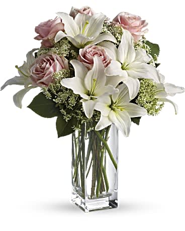 Heavenly and Harmony Bouquet - Stunning in its simplicity, this innocent harmony of light pink roses and snow white lilies are a heartfelt way to send your very best. The classic, clear rectangular glass vase keeps the focus on the heavenly beauty of the blooms.  Light pink roses and white asiatic lilies form a fragrant bouquet with delicate touches of Queen Anne's lace and rich green salal. Delivered in a rectangular clear glass vase.