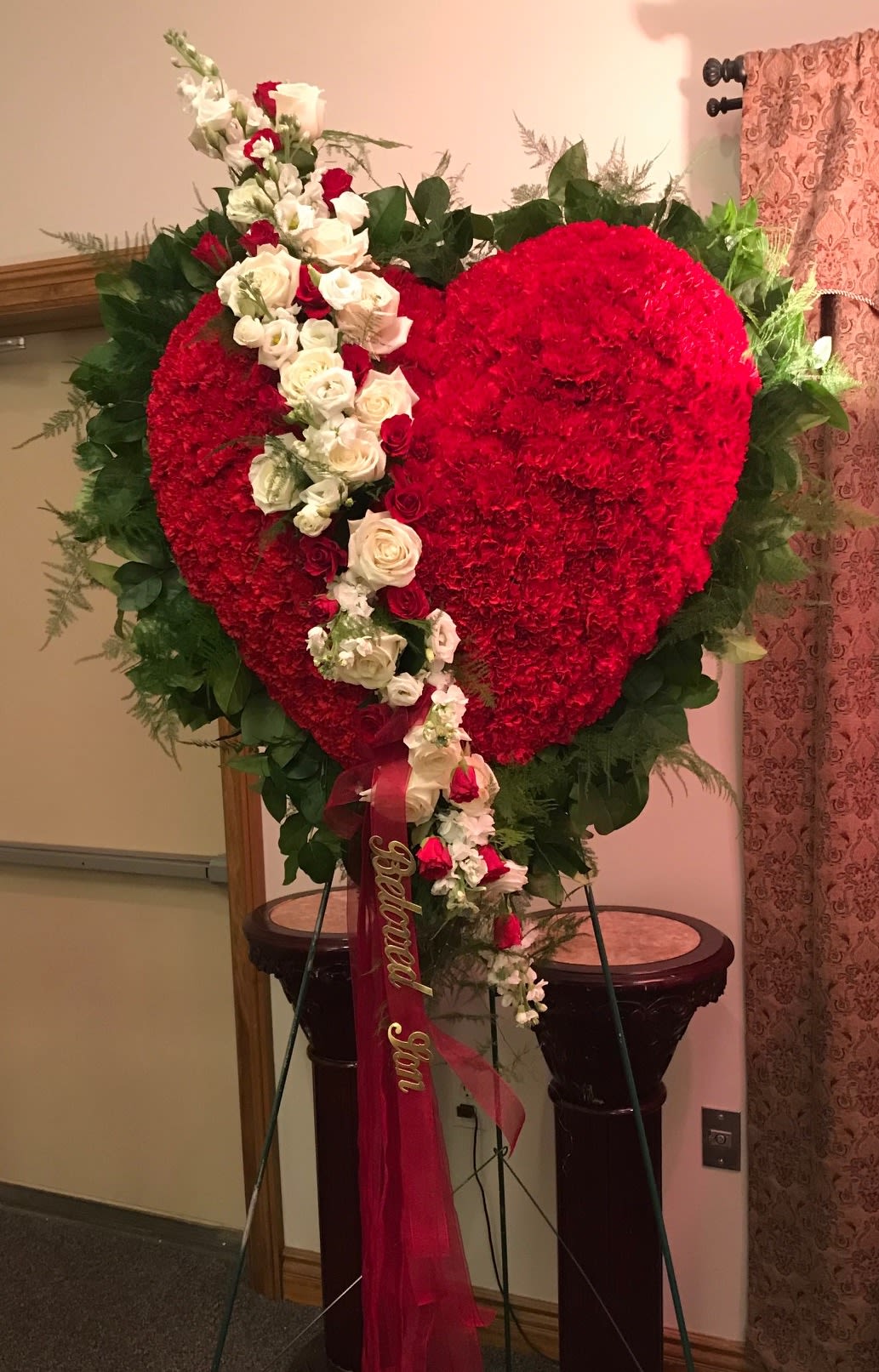 Traditional Bleeding Heart - The traditional bleeding heart is a beautiful display expressing your profound affection for your loved one. Our designs are a large beveled heart with a break consisting of roses and orchids.