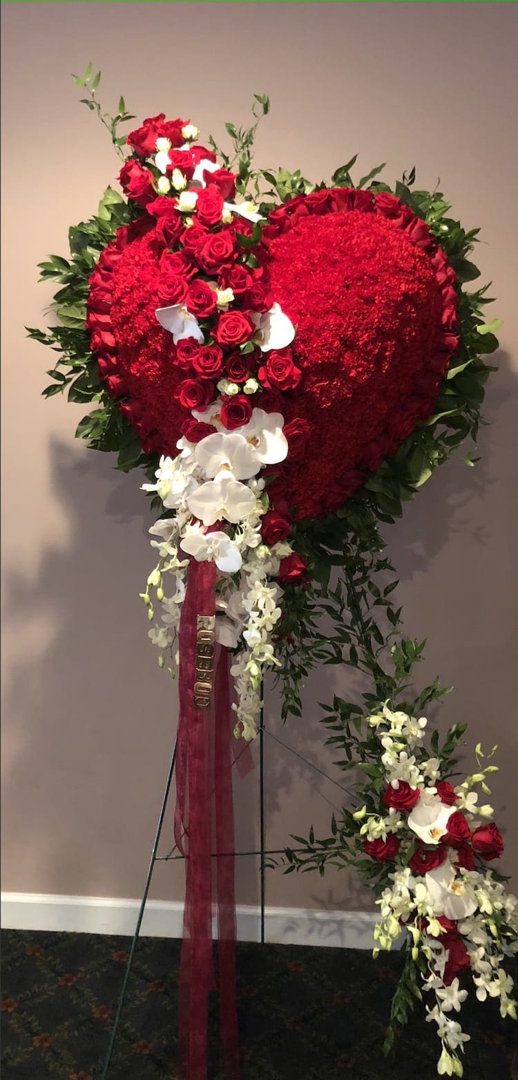 Bleeding Heart with Red Rose Border and Orchid and Rose Break - The traditional bleeding heart is a beautiful display expressing your profound affection for your loved one. This large beveled heart is designed with a red rose border and an orchid and rose break. 