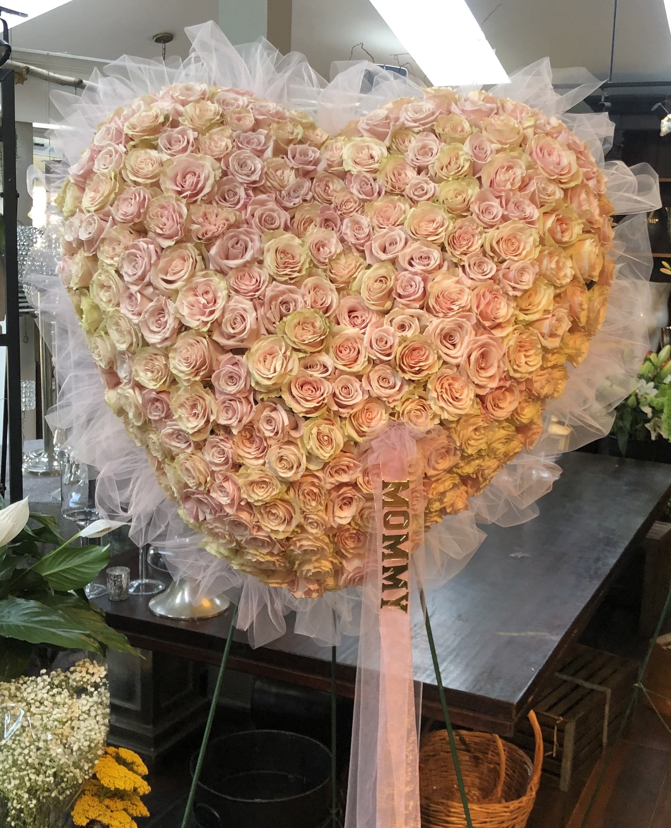 Blush Rose Sympathy Heart - The bleeding heart is a beautiful display expressing your profound affection for your loved one. This large beveled heart is designed with blush roses.