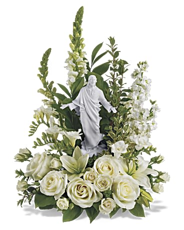 Garden of Serenity Bouquet - This exquisite porcelain sculpture of Jesus surrounded by radiant flowers will be a source of comfort to loved ones during a time of loss. Your thoughtfulness will be long remembered. The stunning bouquet includes white roses, stock, snapdragons, lilies and freesia accented with salal, myrtle and pittosporum. Delivered with a meticulously detailed porcelain sculpture of Jesus.Approximately 15 3/4" W x 22" H