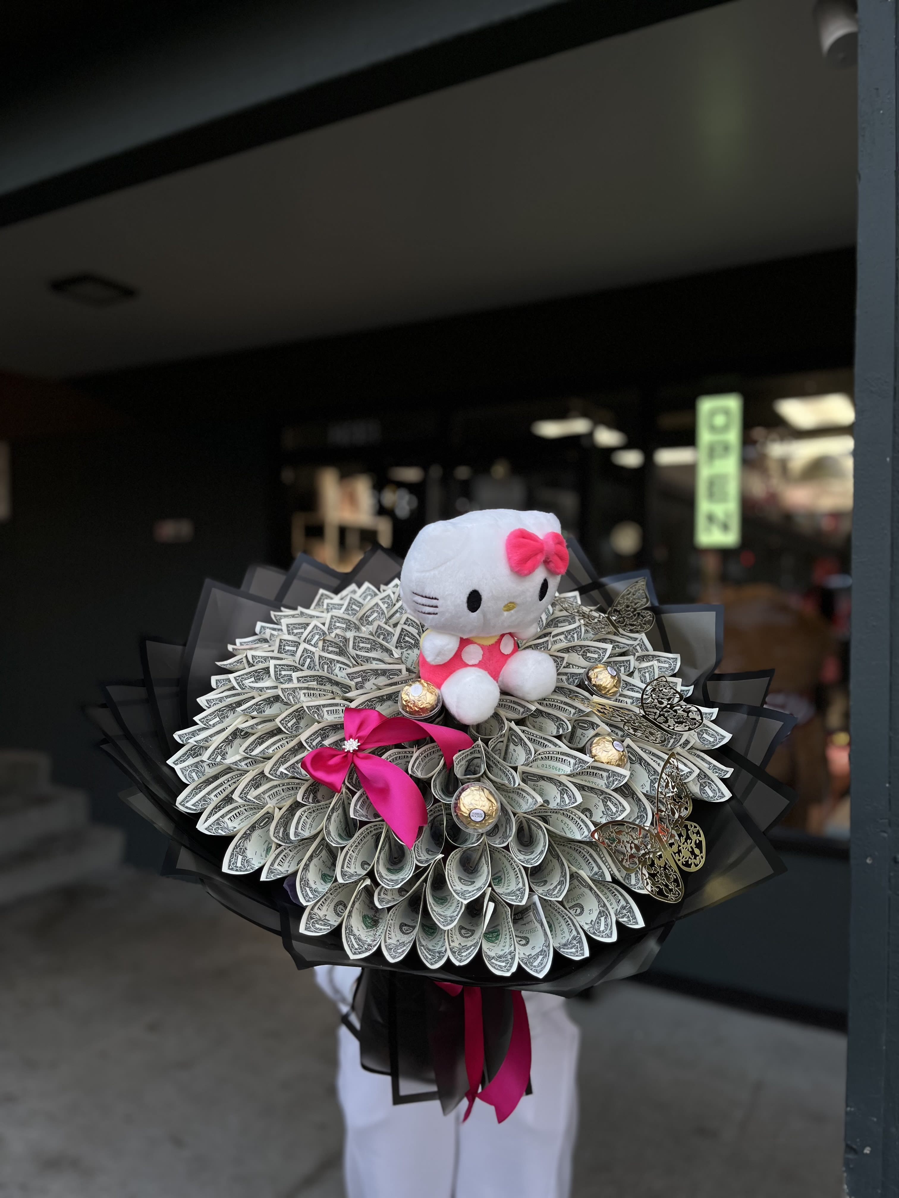Hello Kitty Money Bouquet - A creative and eye-catching money bouquet 100$ crafted from carefully folded banknotes and beautifully accented with a charming Hello Kitty toy. This unique arrangement combines practicality with playful elegance, making it a memorable and joyful gift.  Perfect for birthdays, graduations, celebrations, or when you want to give money in a truly special and stylish way.   