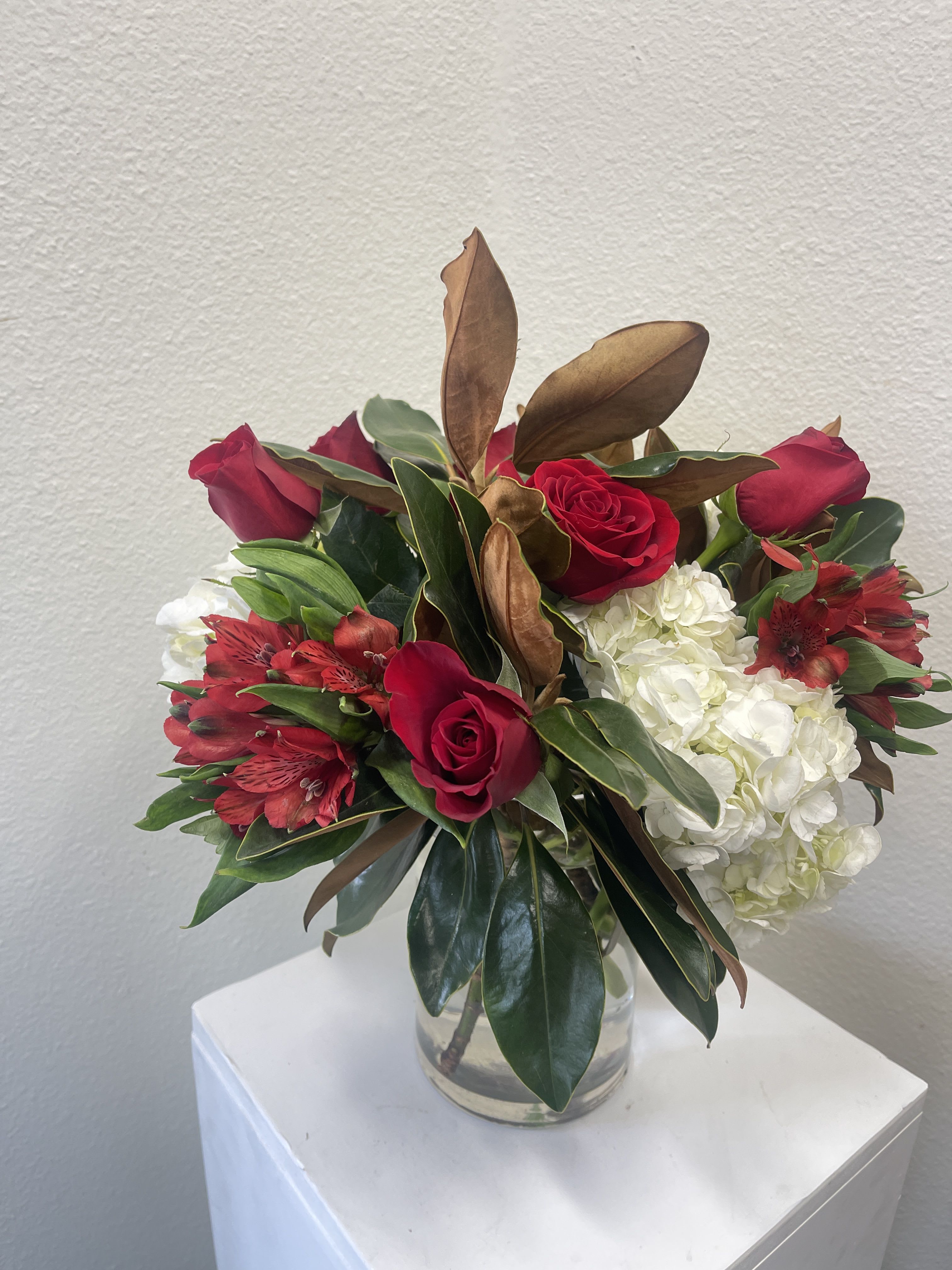 Winter Red - Fresh winter greenery with red flowers.