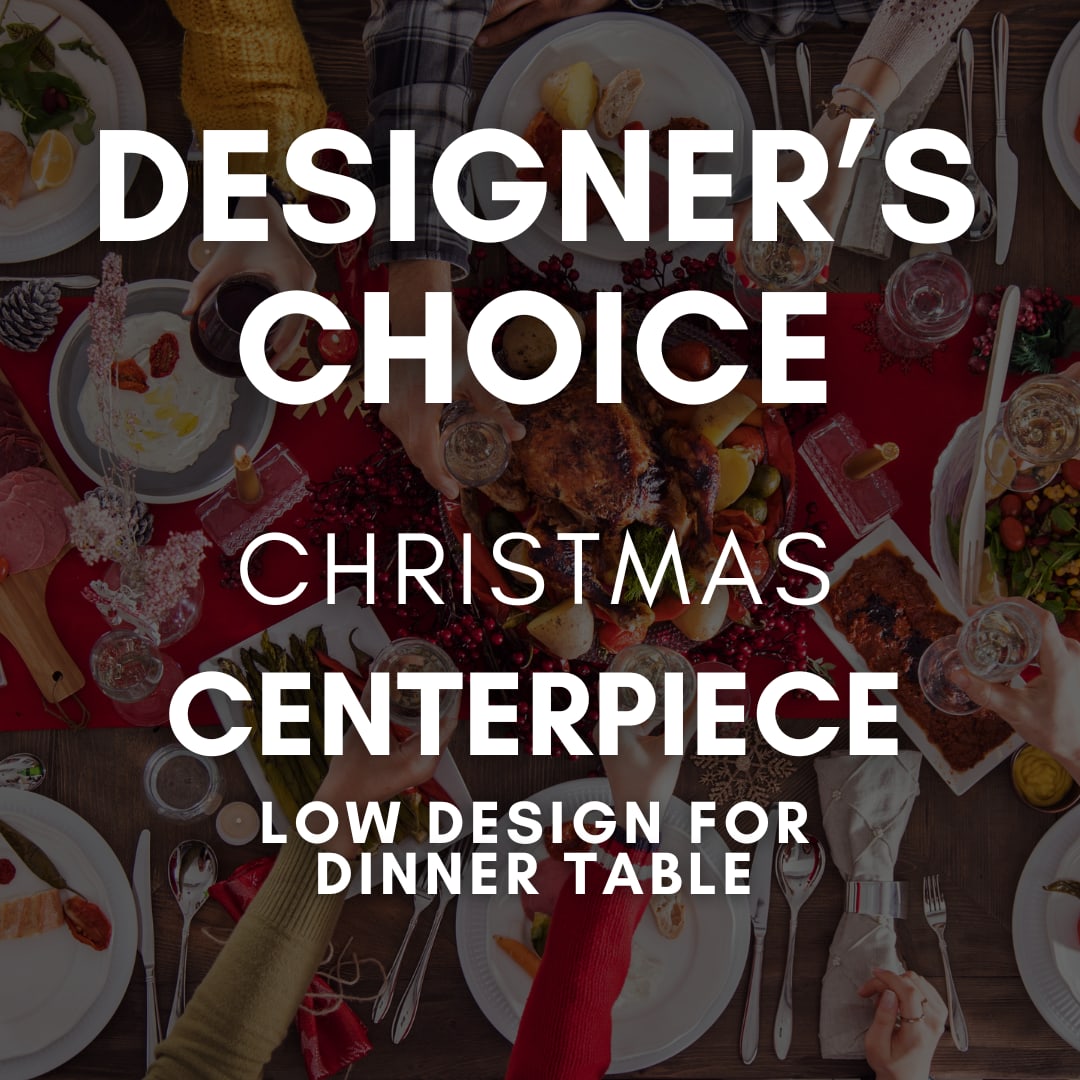 Designer's Choice - Christmas Centerpiece - Designed with gatherings in mind, this low-profile holiday centerpiece is created using the freshest seasonal blooms, winter greenery, and festive accents. Thoughtfully arranged to sit beautifully on your dinner table without blocking conversation, each piece is handcrafted by our designers to feel warm, inviting, and perfectly suited for holiday meals and celebrations.