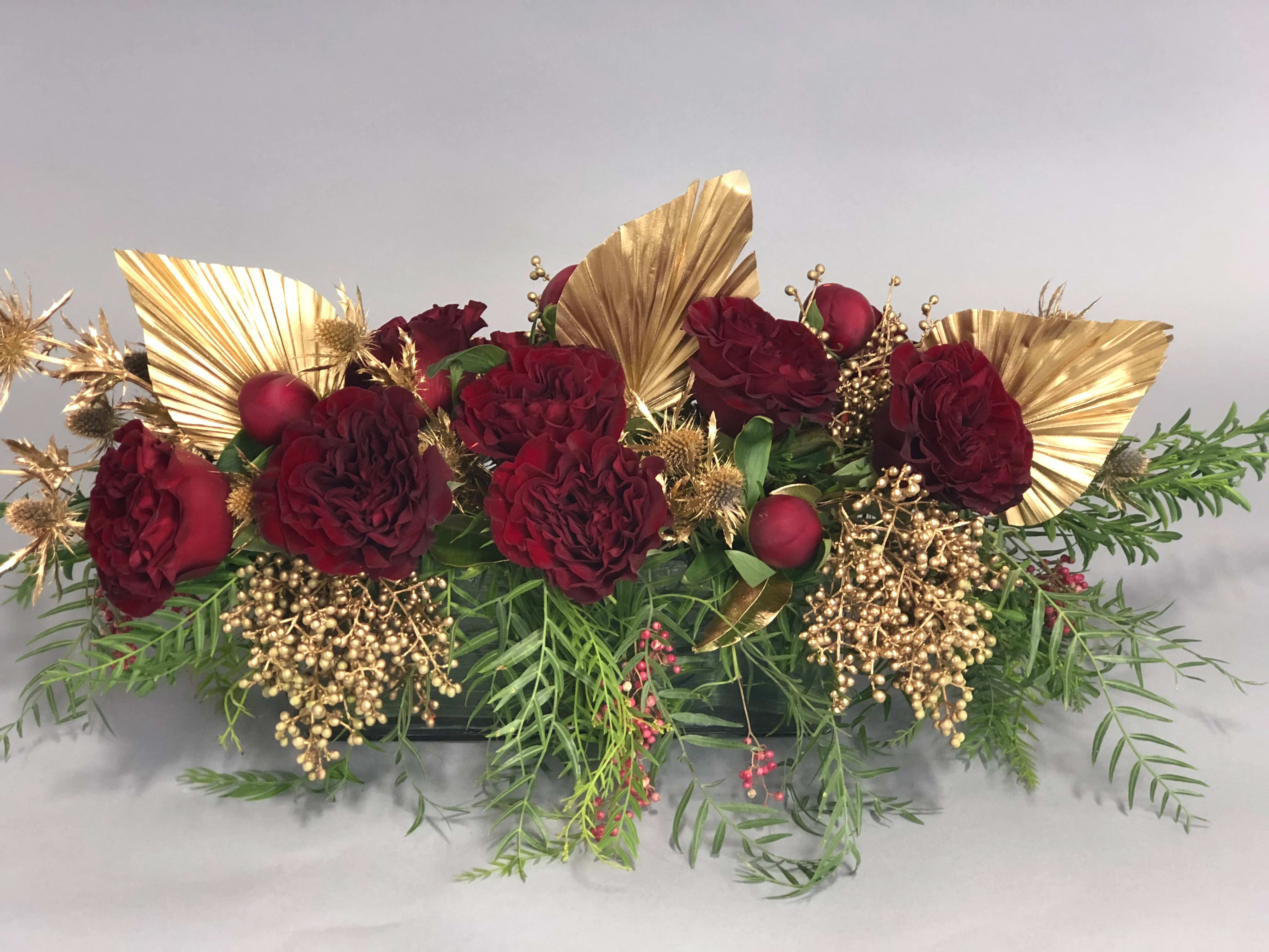 Lunar New Year Centerpiece - This charming modern holiday centerpiece is styled low and lush using premium blooms and gold tinted greens. Perfect for the host who has it all!    DUE TO COVID-19, AVAILABILITY MAY VARY. PLEASE CALL FOR DETAILS. ALL ARRANGEMENTS WILL BE DESIGNER'S CHOICE. DELIVERY DATE AVAILABILITY IS SUBJECT TO CHANGE  This "Heart Rose" focused arrangement is perfect for that golden girl (or guy!) in your life 