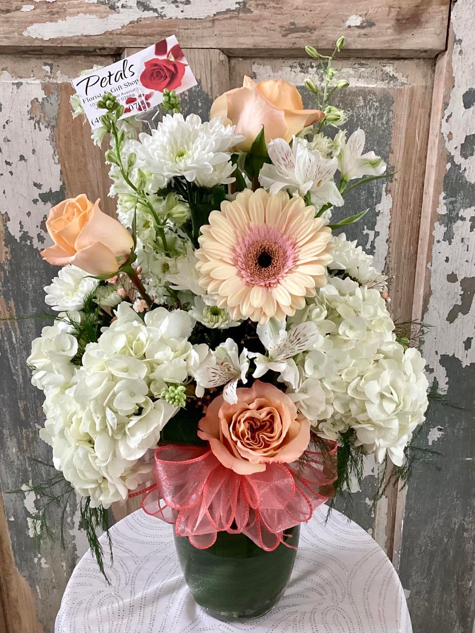 Peaches &amp; Cream by Petals - This bouquet is a Sweet, refreshing delight, designed with fluffy mounds of white hydrangea, peachy/pink roses, Gerber Daisy, chrysanthemums, baby's breath, greens, and filler flowers. Visually enchanting.  *on occasion, flower substitutions may be made based on daily availability. Color may vary slightly due to the natural variations of the fresh flowers  . Thank you, Cheryl