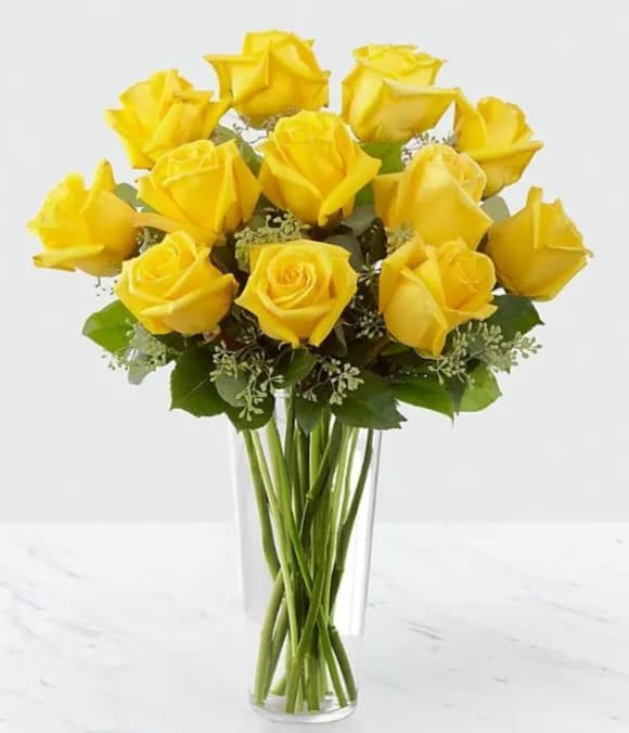 A Dozen Yellow Roses - Sunny yellow roses are a cheery and wonderful gift. Celebrate any occasion with this lively bouquet of roses with seeded eucalyptus in a clear glass vase. Approximately 19"H x 15"W.