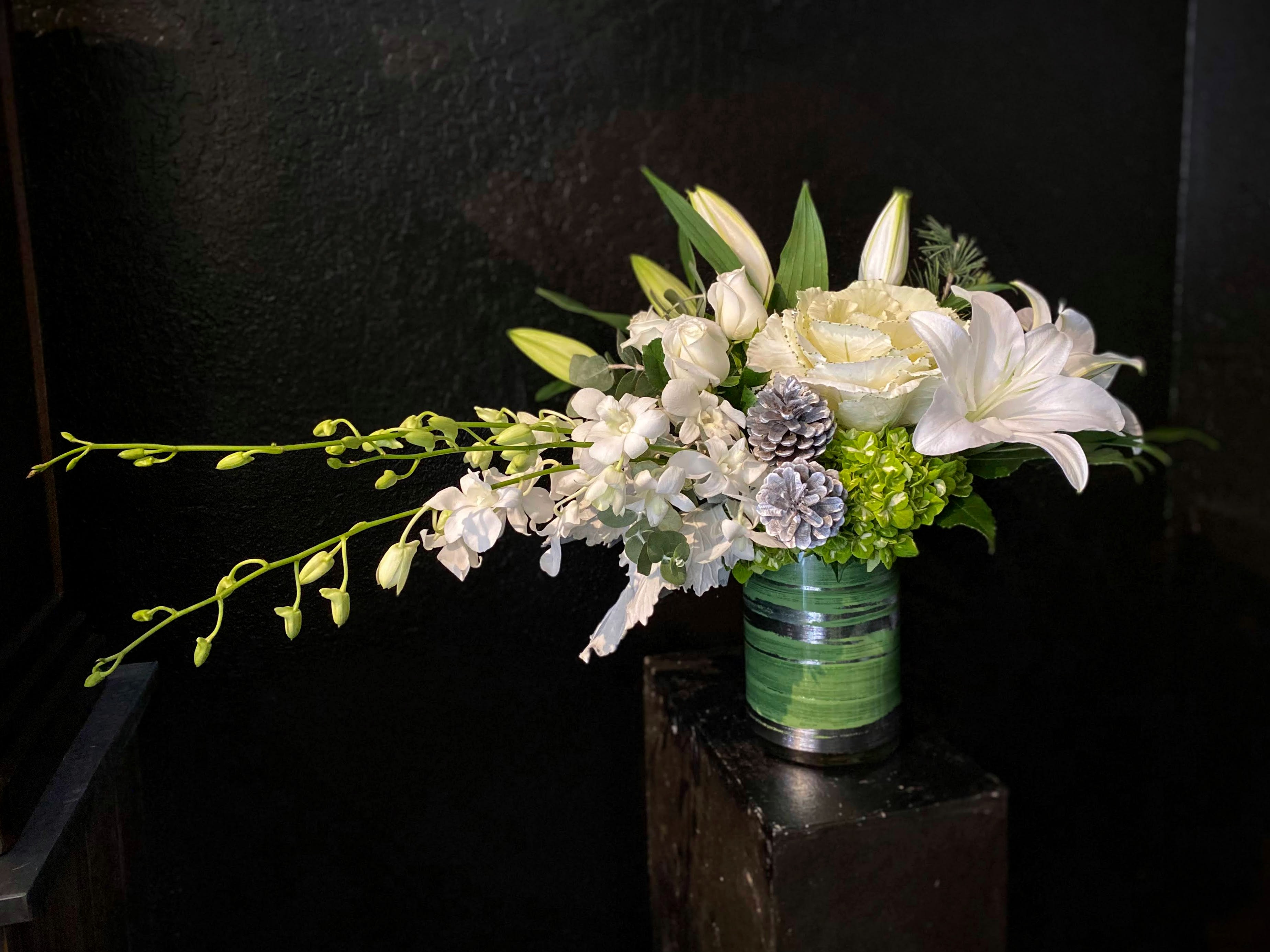 Silver Star - Part of our Winter Contemporary collection, this design looks like a shooting star across the night sky.  Made in all white with silver accents, gorgeous lilies, orchids, roses, and more make this modern and sophisticated design.