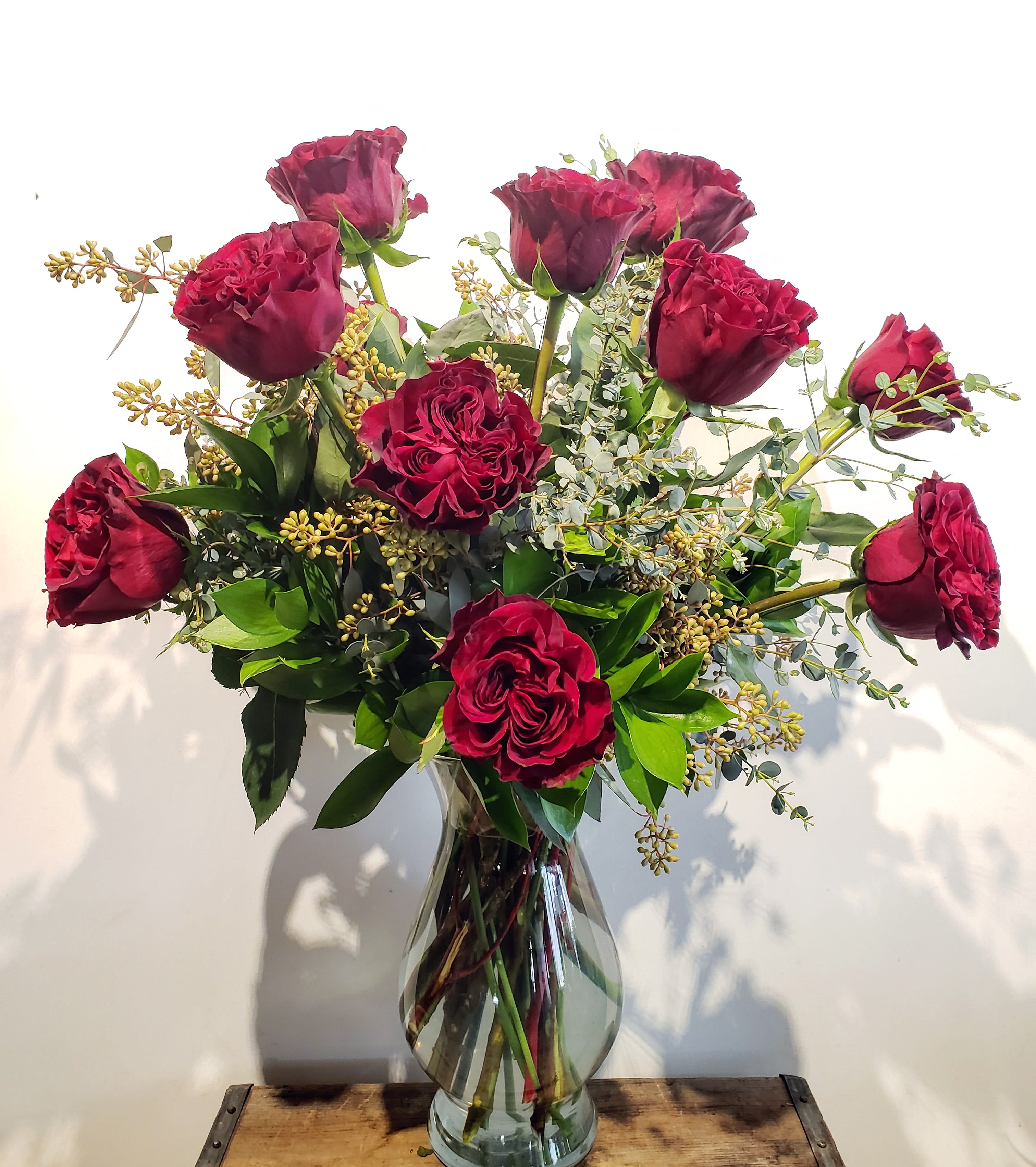 Traditional Dozen Red, Pink, Or White - Make your Sweetheart's day with this exquisite arrangement of one dozen long-stemmed red OR dark pink OR white roses. Please note desired rose color in the florist instruction section upon checkout. We will accommodate these when possible. In the event that we cannot, one of the other colors will be used. 