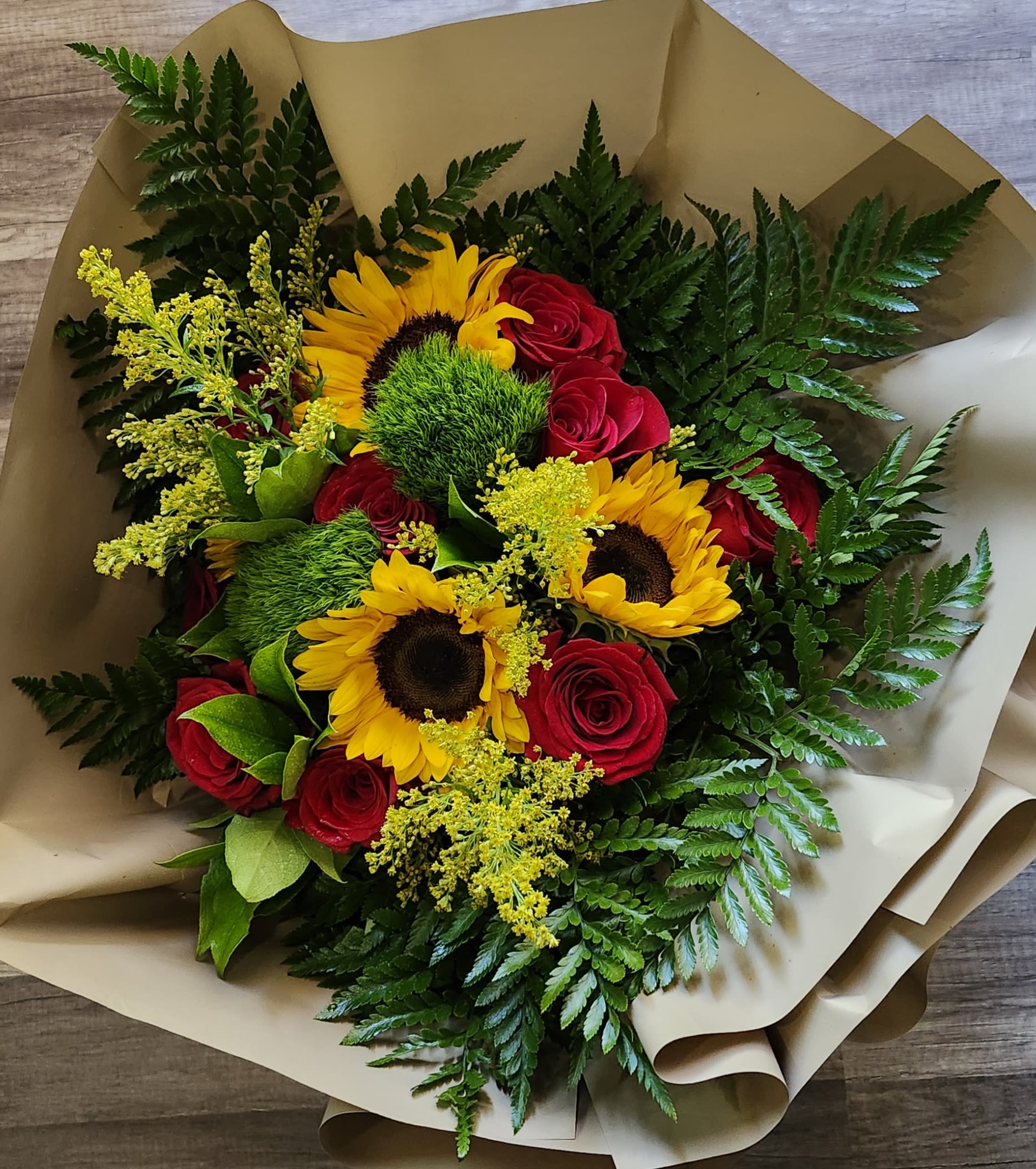 Fire Red Wrap Bouquet - Red Roes, Sunflowers and greenery wrapped in brown floral paper in vase. Standard 6 roses. 