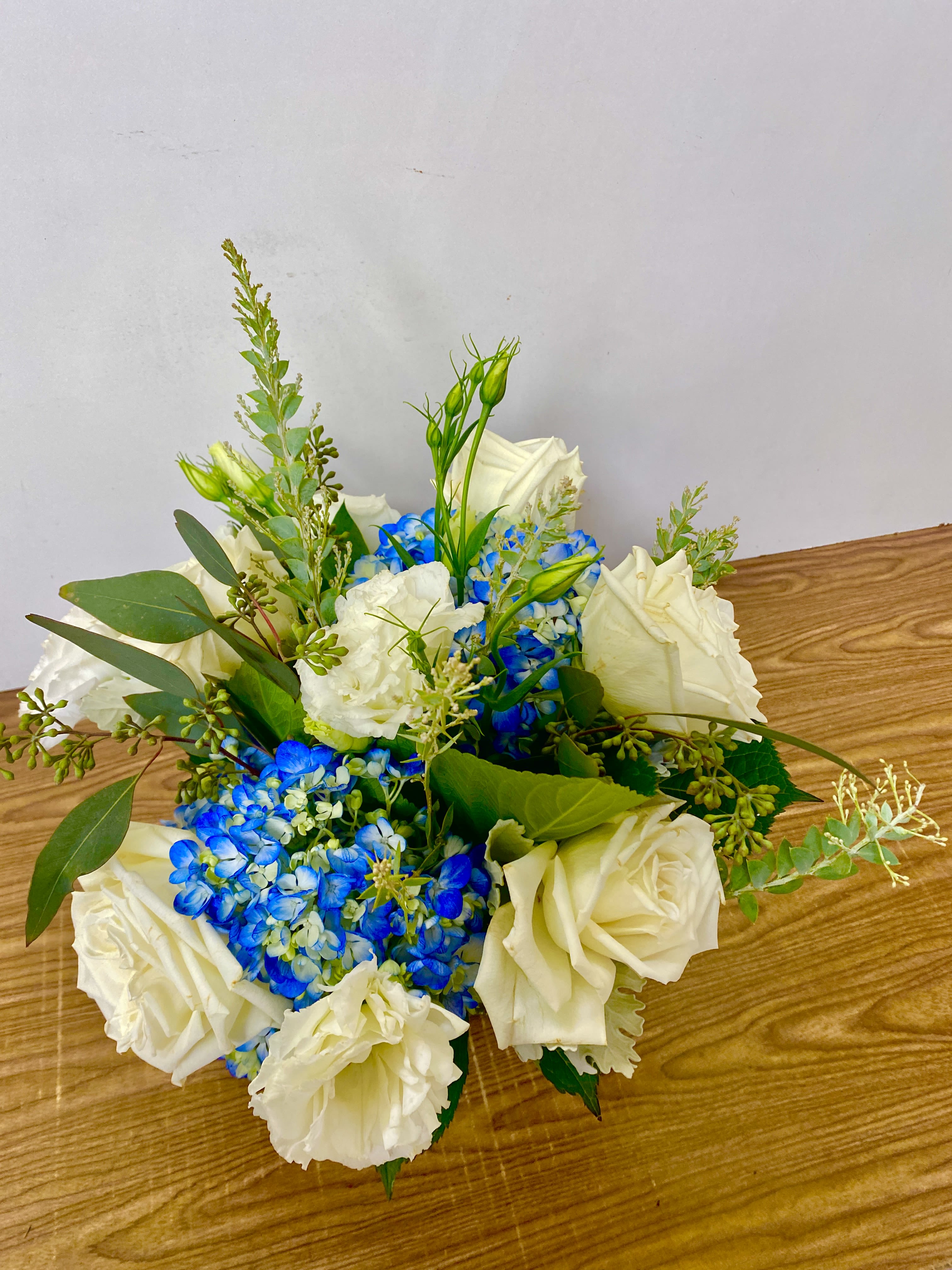 Materialists - in a glass vase hydrangeas, roses, orchids