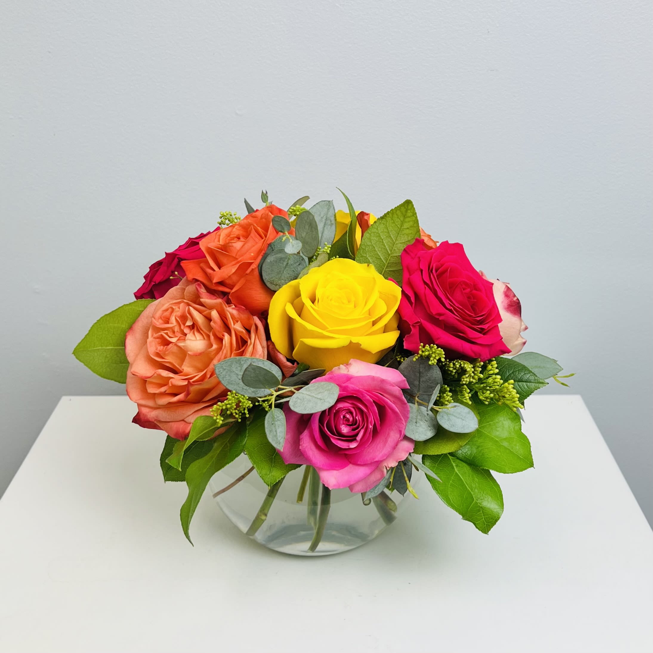 Life of the Party - Celebrate good times with this bold and beautiful assortment of multi colored roses arranged in a bowl. This is a perfect gift for most occasions.   Approximately 10” Tall x 10” Wide
