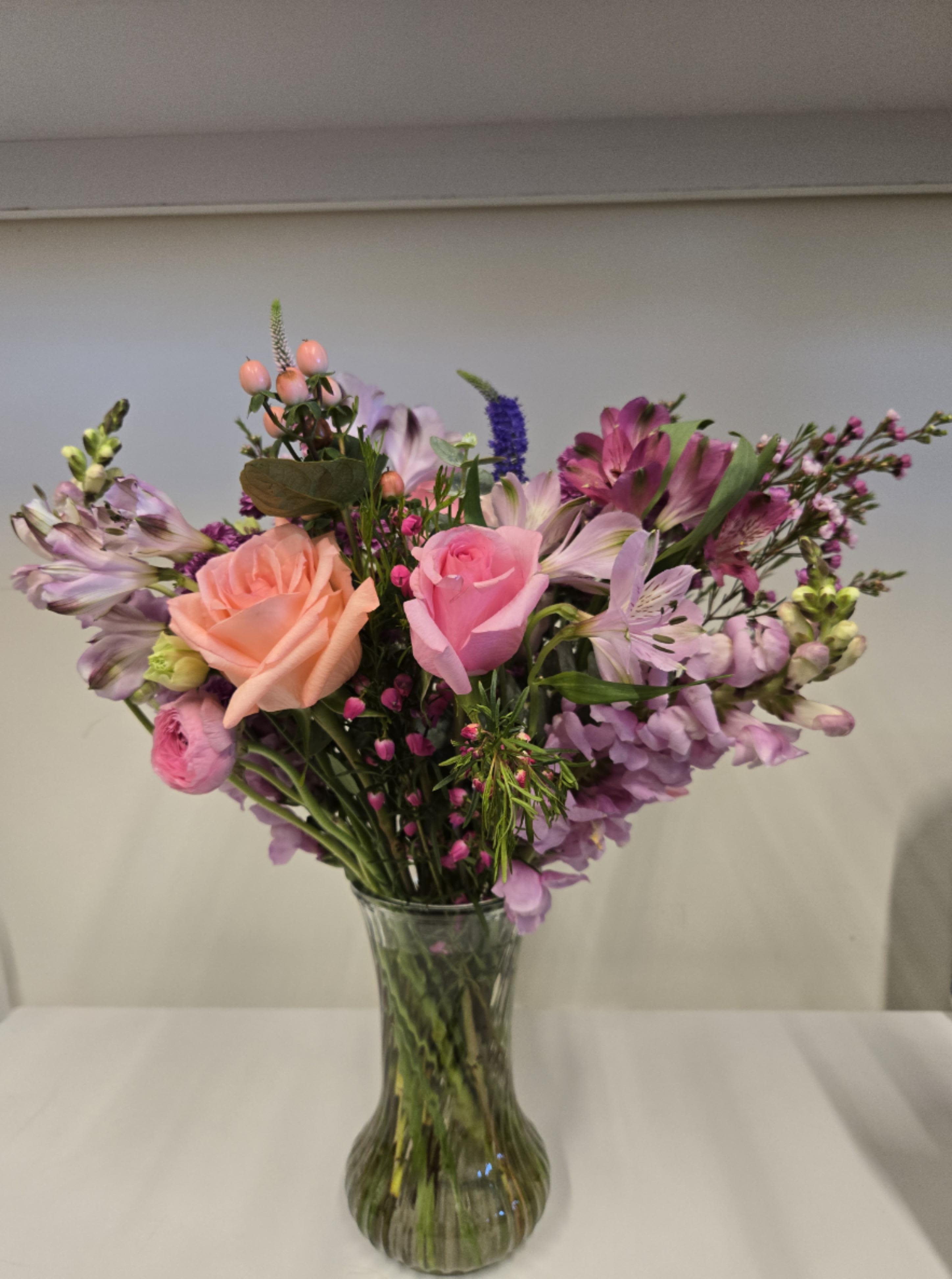 Blushing Pink - Beautifully feminine in pastels and the perfect gift! Contains over 20 stems of different shades of pink, peach, purple and lavender.  Displayed in a clear glass vase.