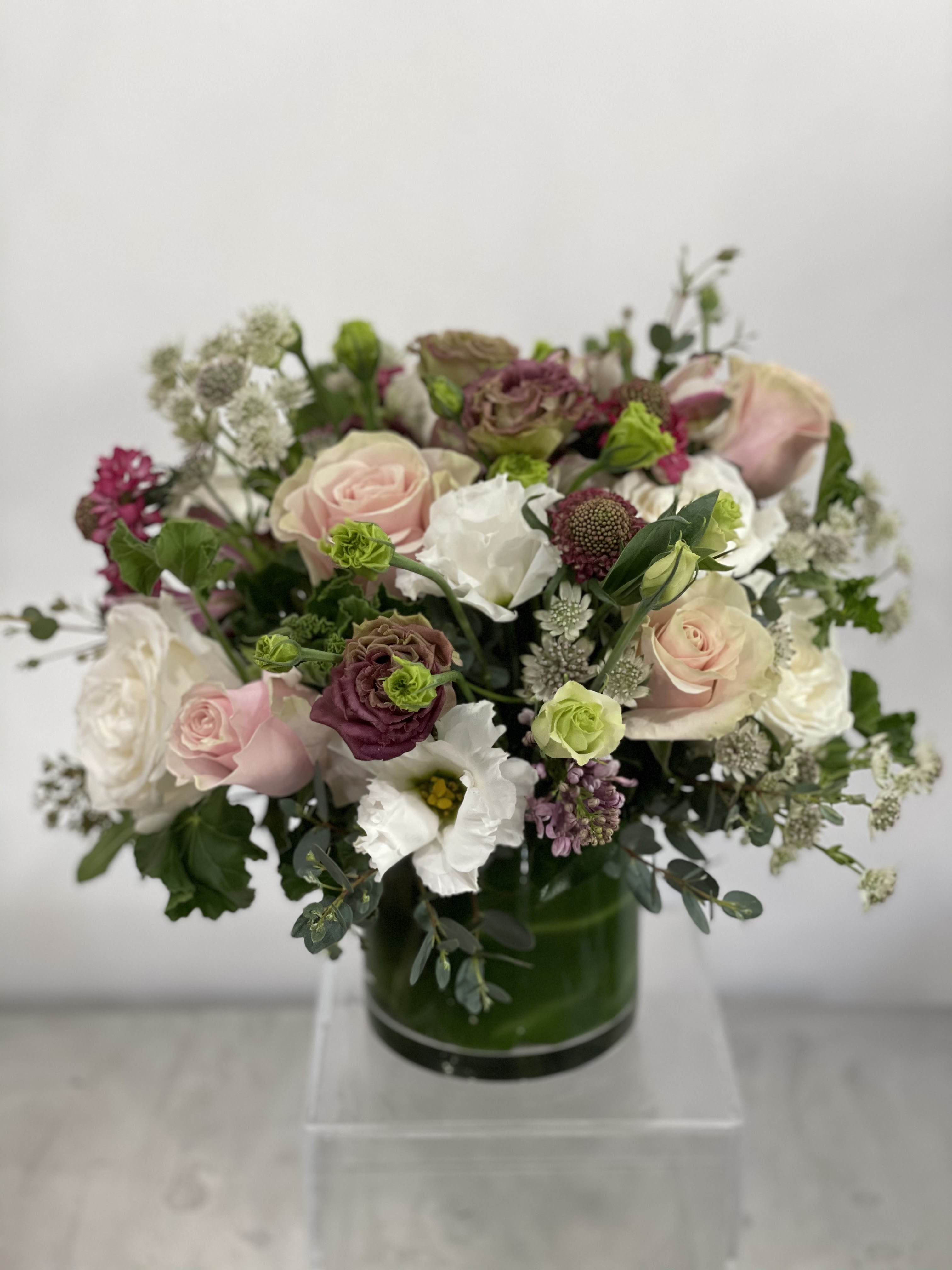 Lady Eloise - English garden style arrangement using designers choice premium blooms in mauve, white, pink, &amp; white with pops of raspberry &amp; touches of minty greens. A beautiful arrangement for a dining room table or coffee table.   If any design element such as color or flower/foliage are very important to your order please contact us to ensure availability first by calling the shop at  415 751 2747 or info @fleurtstyle com 