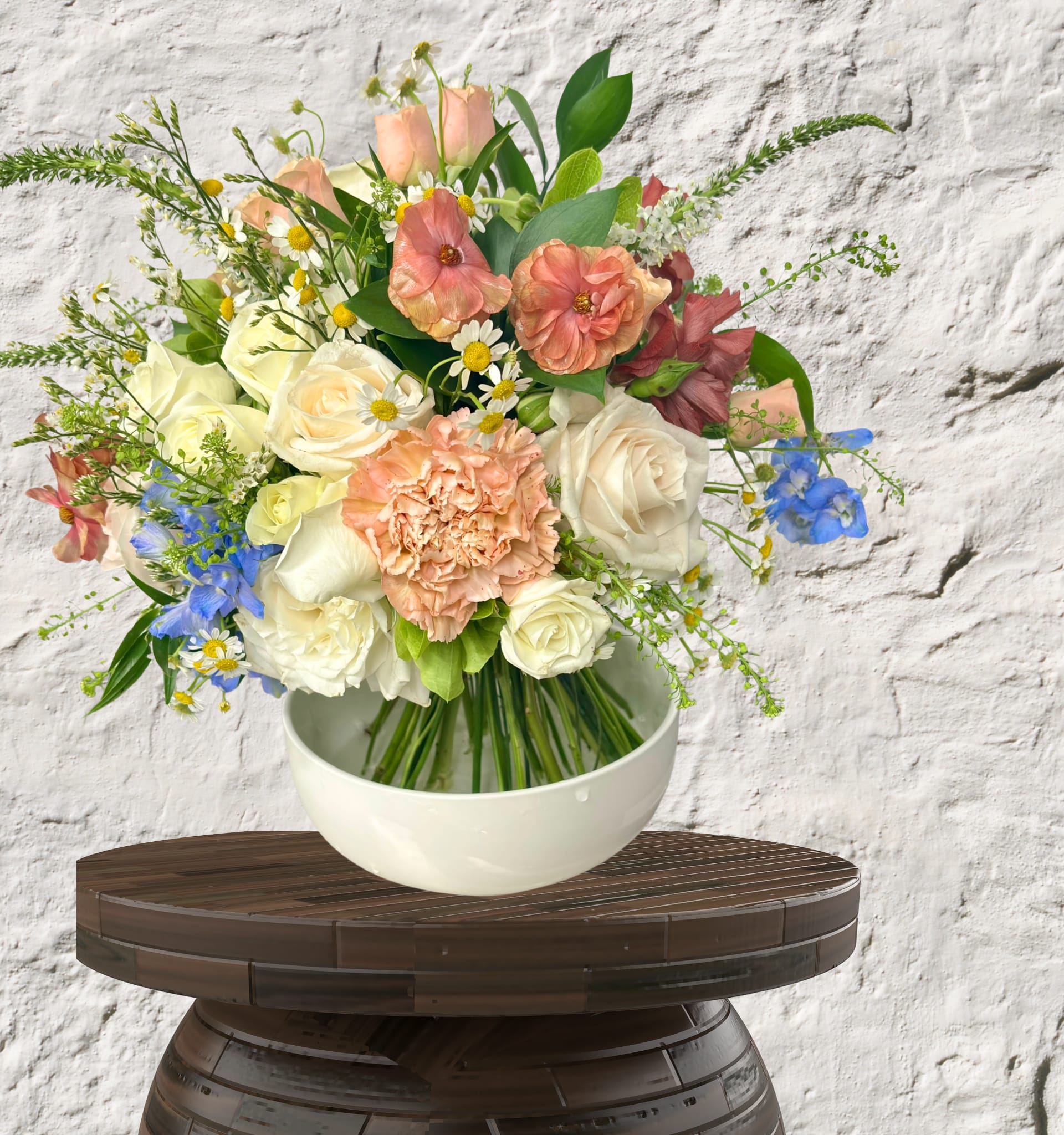 European Hand-tied Collection - Artisan Craftsmanship. Organic Movement. Heirloom Vessels.  Experience the timeless elegance of the European Hand-Tied bouquet—a design style that celebrates the natural, dancing movement of premium stems. Each arrangement is expertly spiraled by hand to create a lush, self-standing silhouette that embodies high-end floral artistry.  The Aesthetic: Boldly Vibrant or Softly Romantic As a "Designer’s Choice" collection, our palettes shift weekly to reflect the most exquisite seasonal arrivals. Whether your arrangement features a Vibrant &amp; Bold jewel-toned story or a Soft &amp; Romantic pastel dreamscape, we guarantee a masterpiece of texture and luxury.  The Foundation: Upscale Vessels We believe a premium bouquet deserves a premium home. Every hand-tied arrangement is paired with a curated, upscale vessel—ranging from heavy-weighted ceramics to architectural glass—ensuring your gift is a complete, permanent piece of home decor.  Select Your Tier of Luxury Standard: A refined, intimate introduction to European design. Features a curated selection of premium focal blooms and seasonal accents in a sophisticated, minimalist vessel.  Deluxe: Our signature size. A lush, medium-scale statement with increased stem density and rare textures, presented in a substantial, high-end statement vase.  Premium: The ultimate expression of opulence. A grand-scale masterpiece featuring our rarest global imports and an oversized, heirloom-quality vessel designed to anchor a room. 