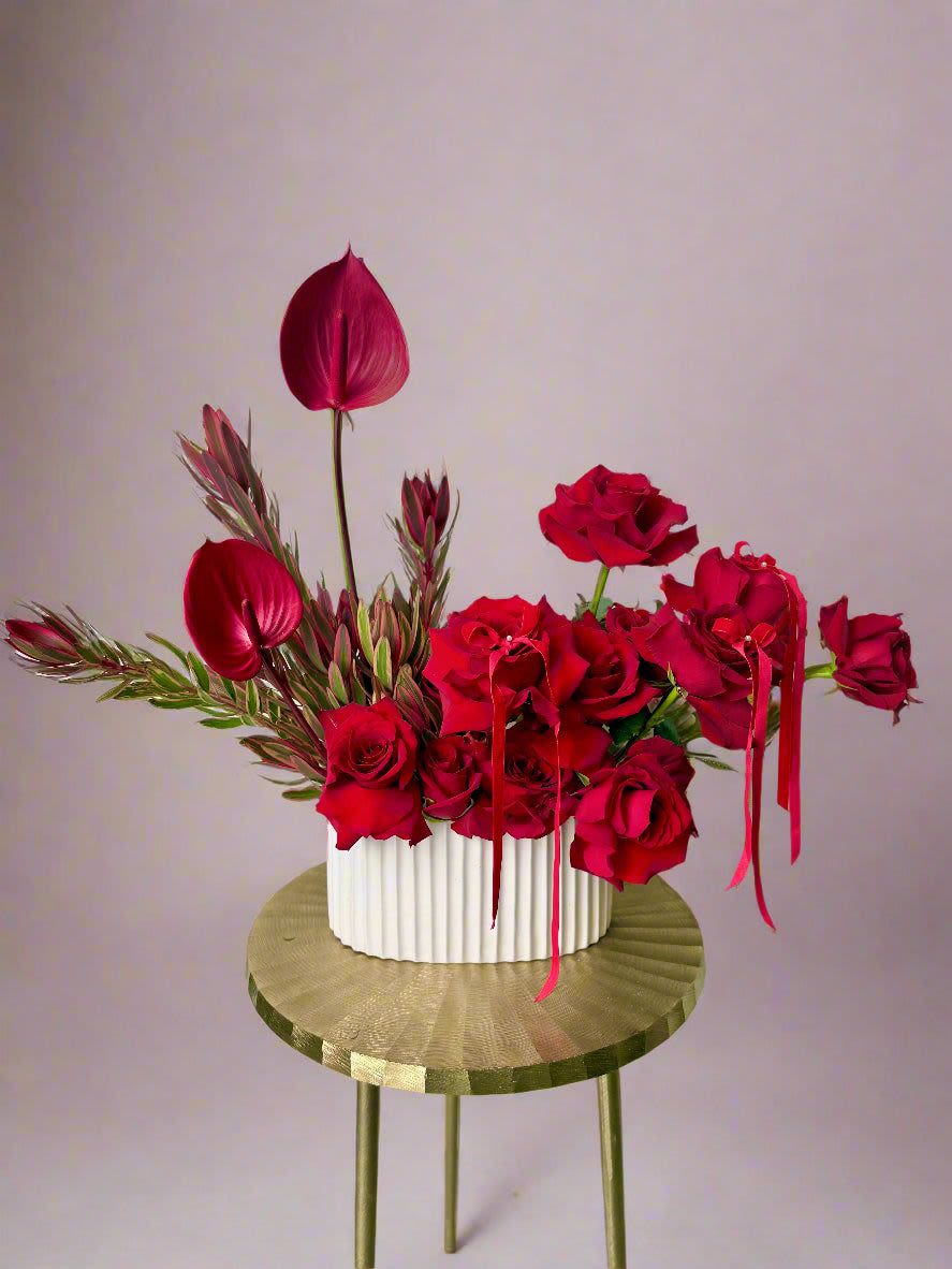 The Editorial Dozen - The Editorial Dozen elevates the classic dozen roses into a stunning floral arrangement worthy of the pages of a magazine. Expertly selected and artfully arranged, these roses showcase exceptional beauty and freshness, making a perfect gift for special occasions or sophisticated décor. Each bloom is carefully nurtured to ensure vibrant color and long-lasting elegance, reflecting Enchanted Florist’s commitment to quality and style.