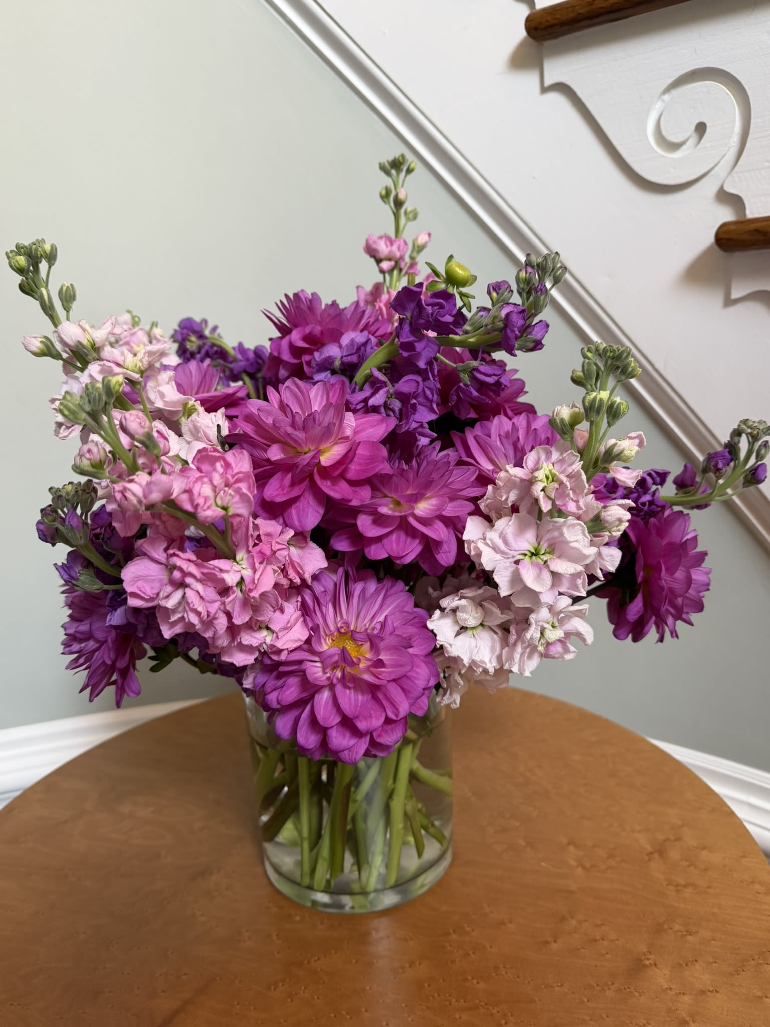 Stock in Dahlias - A pink and purple mass of dahlias and stock delights the senses with rich colors, magnetic fragrances, and varying textures. Perfect for every occasion this arrangement is a stunner worth the investment.