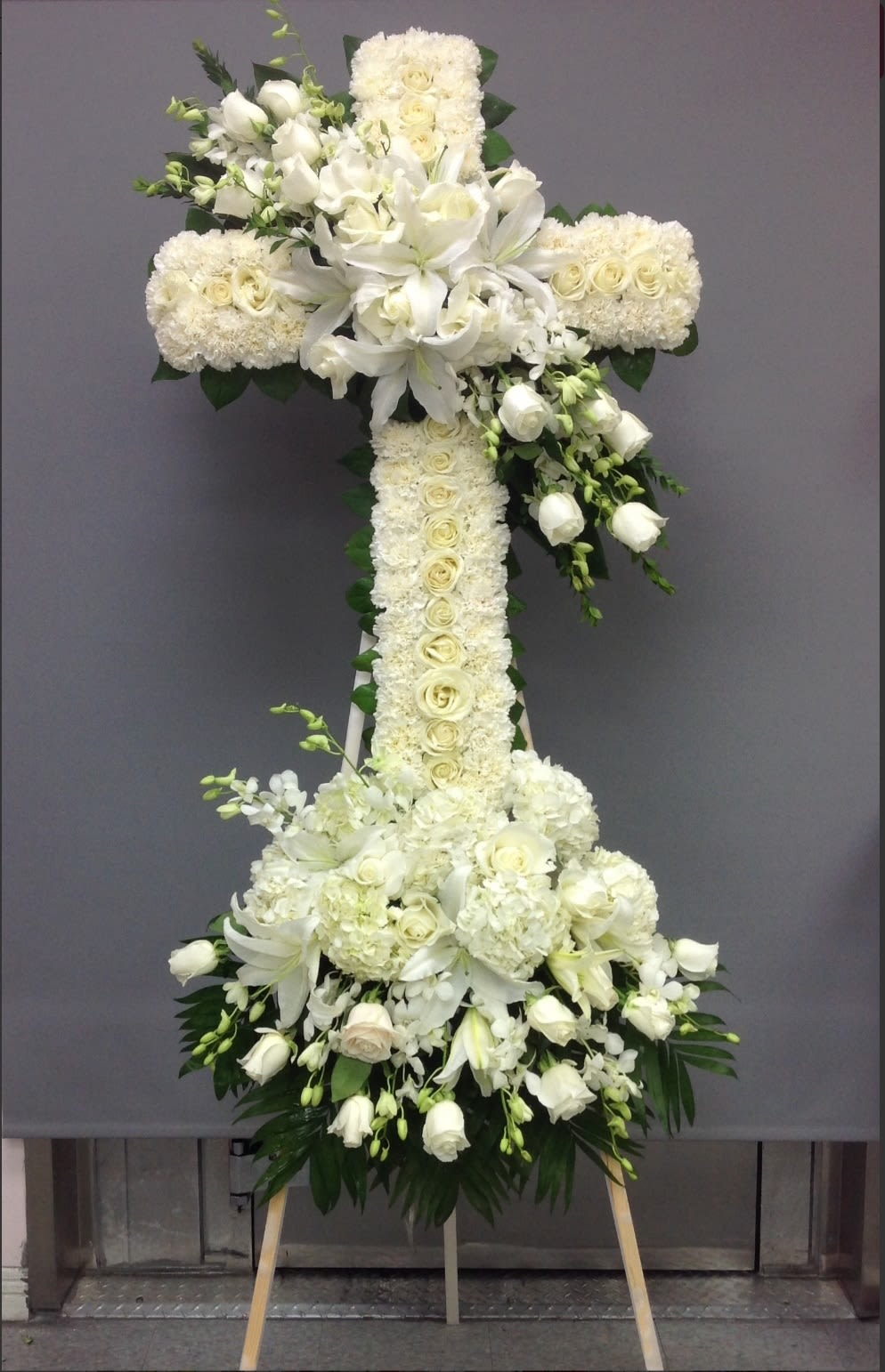  All White Cross - An all white standing funeral cross delivered straight to your event. This standing spray comes with a stand.