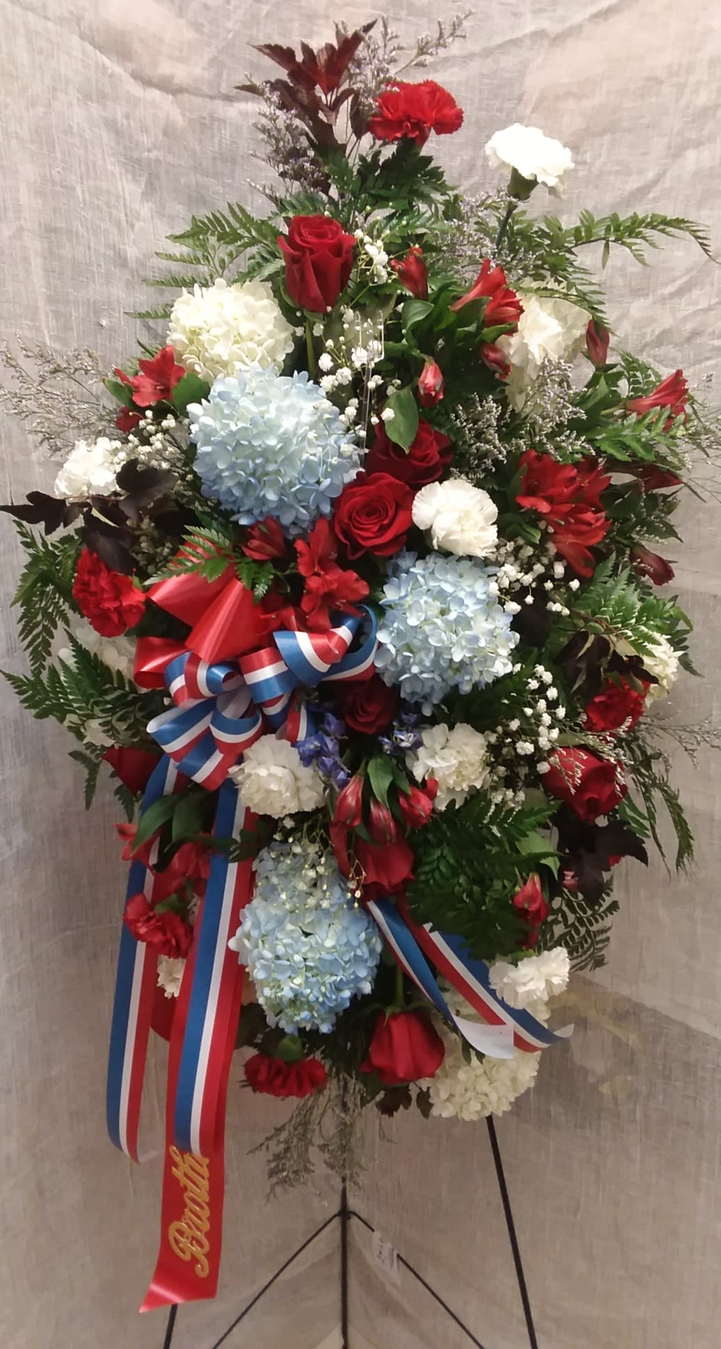Patriotic Standing Spray  - American proud spray with hydrangea, carnations, roses, alstroemeria, limonium, and baby's breath.