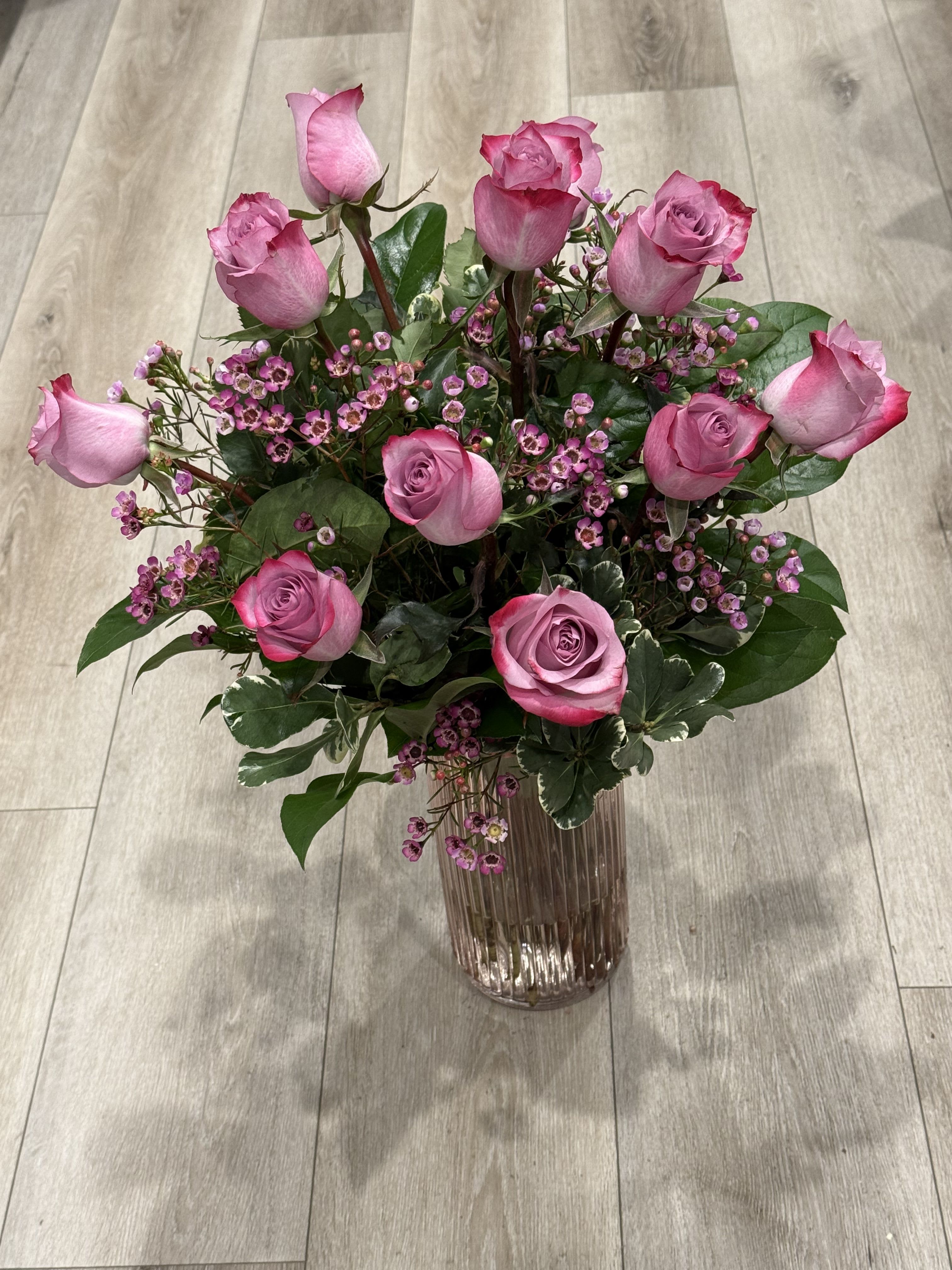 Fairytale Love - Beautiful lavender bouquet   Dark lavender bicolor roses, wax flower and in season greenery  Standard 12dozen Deluxe 18 roses Premium 24 roses